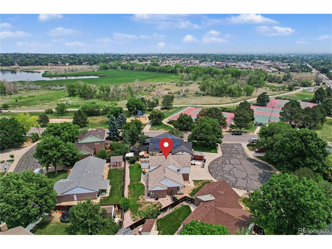 NO HOA! Perfectly positioned in the heart of Eastlake Village, this beautifully maintained tri-level home sits directly across the street from a park, lake, and scenic walking trails, offering an exceptional blend of comfort, convenience, and outdoor recreation. One of the property's standout features is the rare 40-foot gated RV parking area, providing secure space for an RV, boat, trailer, or additional vehicles. Tucked away on a peaceful cul-de-sac, the home is also just steps from the Eastlake Nature Preserve, six neighborhood tennis courts, and a nearby playground. Inside, the open multi-level floor plan is filled with natural light and enhanced by soaring vaulted ceilings. The kitchen features stainless steel appliances, warm oak cabinetry, and a casual breakfast nook overlooking the backyard. The inviting lower-level family room offers a comfortable gathering space with rich hardwood flooring and a classic brick fireplace that adds warmth and character.Upstairs, the private primary retreat features vaulted ceilings, a generous walk-in closet, and a spacious five-piece bath. Two additional bedrooms share a convenient Jack-and-Jill bathroom, creating a functional layout for family members or guests.The backyard provides plenty of room to relax, entertain, or garden, with a patio ideal for enjoying Colorado evenings. A large storage shed adds valuable space for tools and equipment, while the fenced RV parking area offers exceptional versatility.Additional highlights include a desirable south-facing driveway that helps reduce winter snow accumulation, an oversized two-car garage with extra storage or workspace, and numerous recent improvements, including a new roof and air conditioner in 2025, plus new carpet and window blinds installed in 2026. With no HOA, incredible outdoor amenities just across the street, and a highly desirable Eastlake Village location, this home offers the Colorado lifestyle you've been looking for.