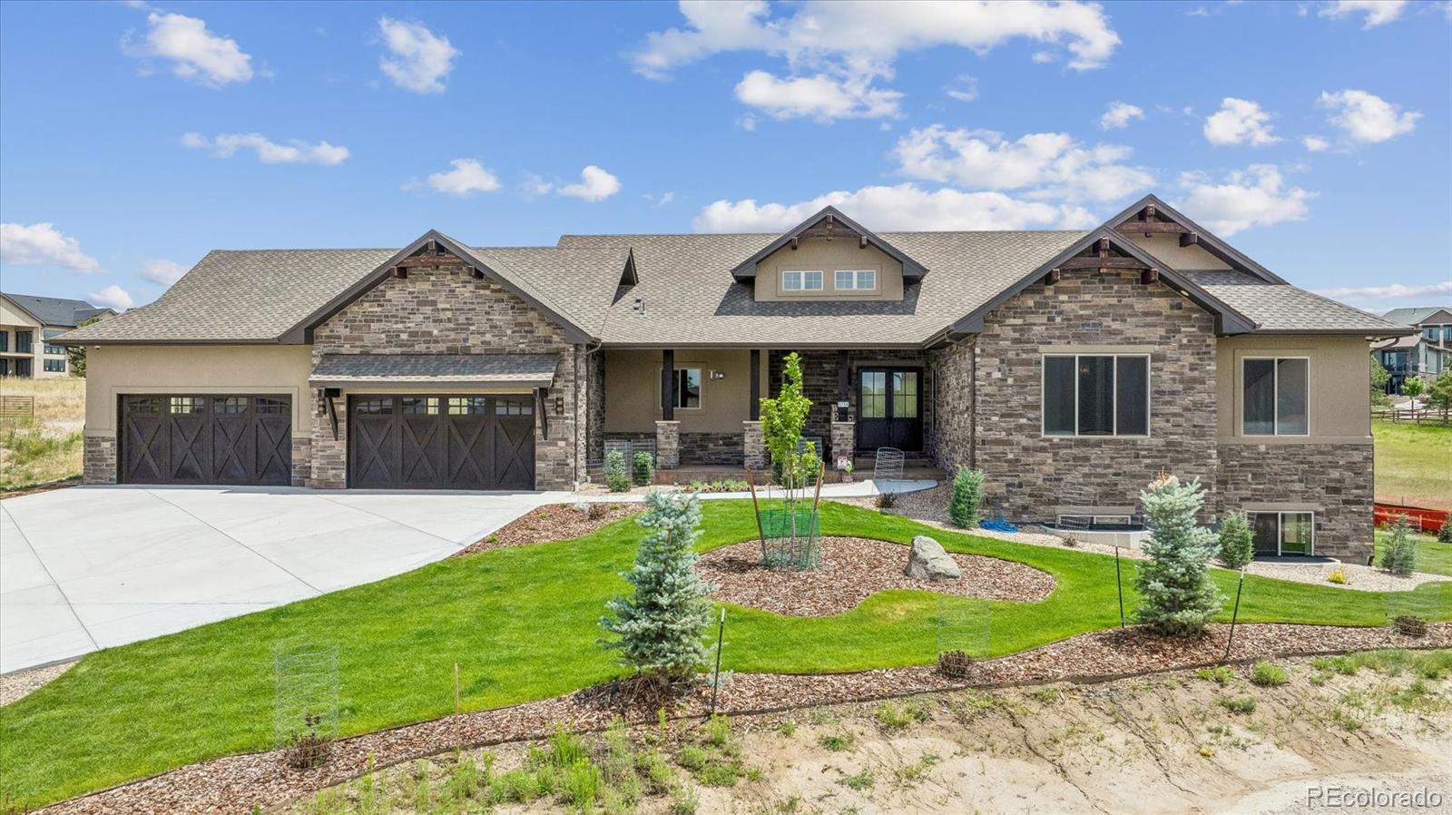 Luxury mountain contemporary ranch walkout in The Timbers, one of Parker's most sought-after custom home communities. Perfectly positioned on a premium homesite, this exceptional residence showcases sophisticated Colorado architecture, an open-concept floor plan, and designer finishes throughout. Every detail has been thoughtfully curated to create an effortless blend of elegance, comfort, and modern functionality. The expansive great room is anchored by dramatic ceilings, abundant natural light, and seamless flow into the gourmet kitchen, creating the ideal space for entertaining and everyday living. The stunning kitchen features premium appliances, custom cabinetry, an oversized center island, and a separate back kitchen that keeps preparation and cleanup discreet. Walls of glass connect the interior to an expansive covered deck, extending the living space outdoors and providing the perfect setting for year-round Colorado entertaining. The luxurious primary suite offers a peaceful retreat with spa-inspired bath, oversized walk-in closet, and refined designer finishes. The finished lower level provides exceptional flexibility with spacious recreation and media areas, additional guest accommodations, and direct access to the beautifully landscaped backyard. Technology enthusiasts will appreciate the home's fully automated smart home system, allowing effortless control of lighting, audio, climate, security, and entertainment from virtually anywhere. Additional highlights include an oversized 4-car garage, custom millwork throughout, premium stone and tile selections, and designer lighting. The neighborhood enjoys towering Ponderosa pines, scenic walking trails, nearby golf courses, top-rated schools, and convenient access to downtown Parker and Castle Rock. Offering the perfect combination of mountain contemporary style, luxury finishes, and ranch walkout living, this remarkable custom home delivers the Colorado lifestyle today's discerning buyers are looking for.