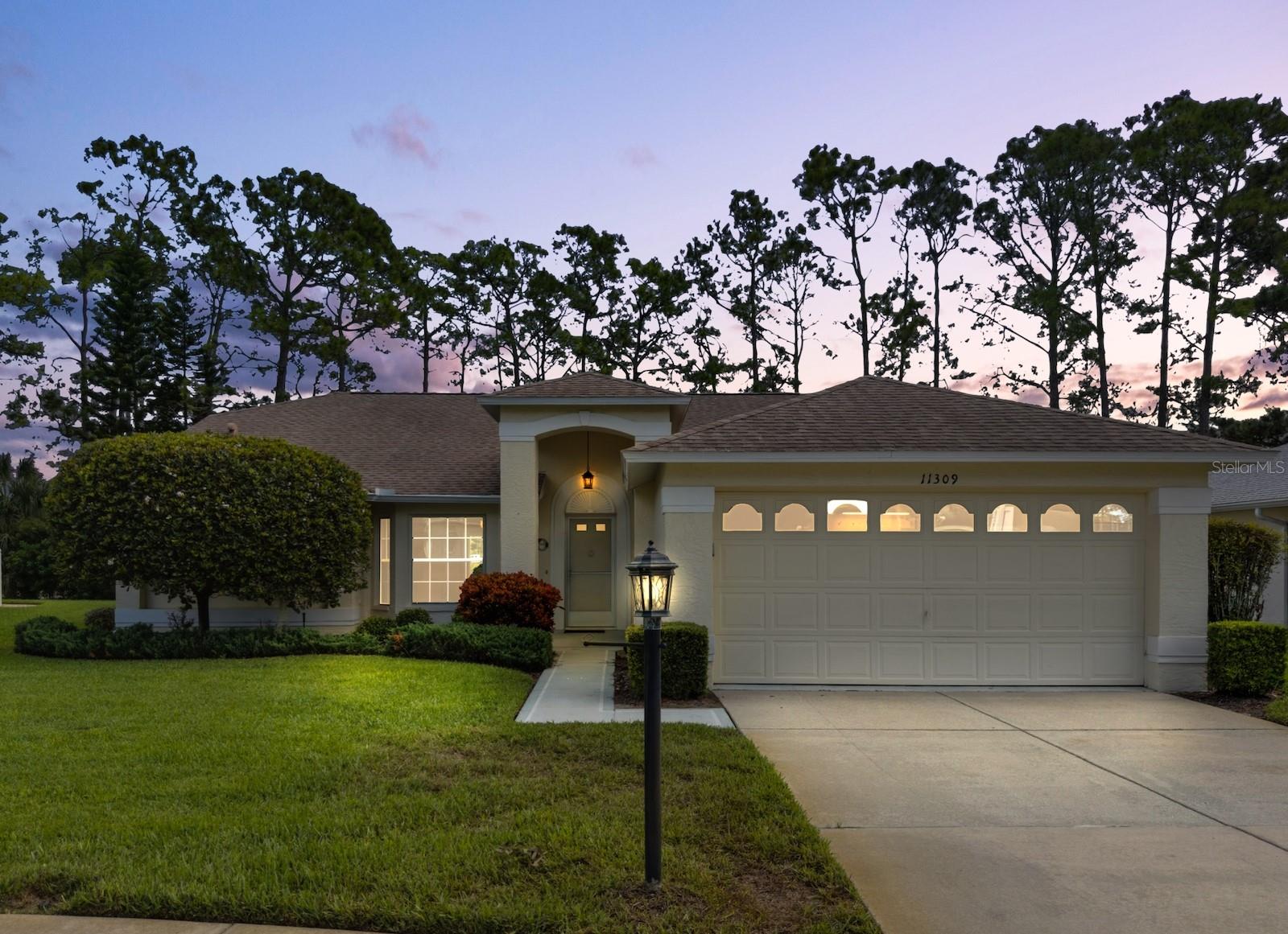 Welcome to this beautifully updated home in the highly desirable Heritage Pines 55+ Golf Community. Offering over 2,100 square feet of living space and no rear neighbors. Inside, soaring cathedral ceilings enhance the open living and dining room combination, while fresh interior paint, new lighting, and modern ceiling fans throughout create a bright, inviting atmosphere. Most of the home features newer vinyl plank flooring for a seamless and contemporary look. At the heart of the home, the remodeled kitchen showcases granite countertops, new cabinetry with stylish hardware, brand-new stainless steel appliances, a breakfast bar, and a cozy dinette, all overlooking the spacious family room. The split-bedroom layout provides privacy, with the primary suite offering dual walk-in closets and a beautifully updated en-suite bathroom with a new custom dual sink vanity with granite countertops. The guest wing includes a large bedroom with walk-in closet, a built in queen-size Murphy bed, and a refreshed guest bath. At the rear, a large Florida room with sliding doors from both the dinette and dining area provides the perfect spot to enjoy serene views of the green retention area and partial golf course vistas. Recent updates add peace of mind, including a roof (2018), AC(2020) with new blower motor(2025), and a brand-new water heater (2025). A golf cart is also included. Heritage Pines residents enjoy a true resort lifestyle with an 18-hole championship golf course, clubhouse with restaurant and bar, pool and spa, fitness center, and courts for tennis, pickleball, and bocce. HOA fees cover cable, internet, lawn care, and irrigation for easy, low-maintenance living. Don’t miss the opportunity to make this exceptional home yours—schedule your private tour today!