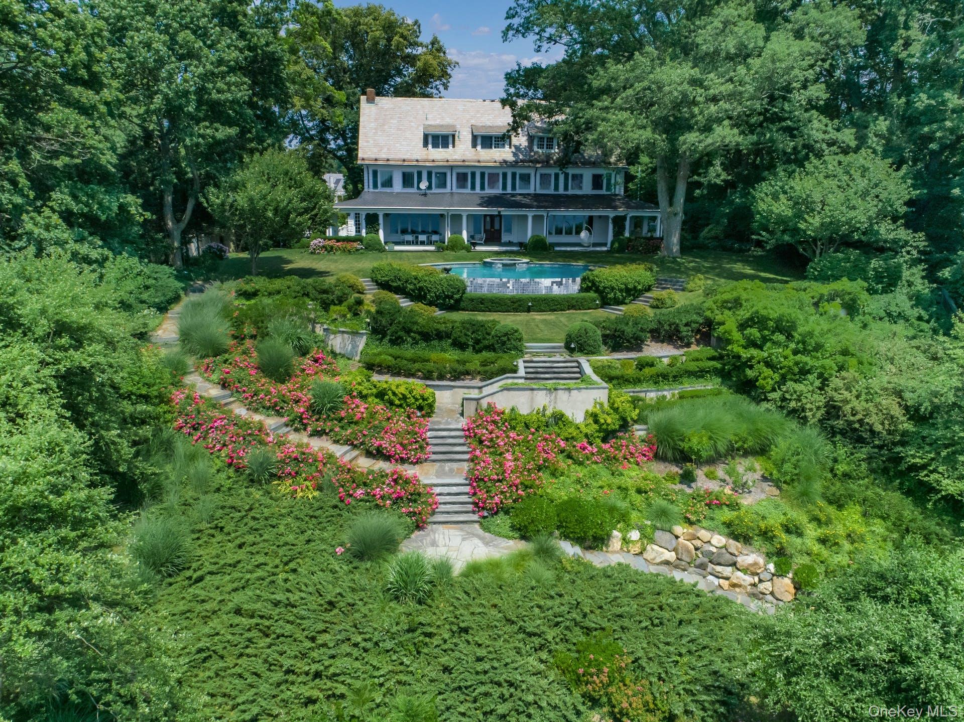 Exquisite, unique Sands Point location with classic and elegant Colonial accents resting above Manhasset Bay with spectacular sunsets, LI Sound and Manhattan Views. Property has a coveted deep water dock, 145 feet of private beach. Enjoy the infinity pool and covered porch, overlooking magnificent gardens and your own private oasis. This estate has multiple fireplaces and classic architecture along with many updates and amenities. A separate completely renovated 2 bedroom guest house accommodates extended family, guests, or household staff. This waterfront home boasts a serene and beautiful waterfront lifestyle that is exceptional and irreplaceable!!!