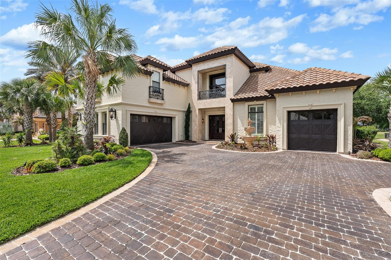 Designed for a luxurious lifestyle, this French Mediterranean Mini Mansion has just undergone an extensive design change and renovation. With its wrought iron Juliet Balconies, marble stoops, oversized trim, French Scroll corbels and the Old-World stucco with custom color finish is truly a timeless classic. A Versailles inspired fountain greets you as you enter the courtyard. The paver driveway has been custom hand stained for a cobblestone look and feel. New exterior lighting to accentuate the refined luxury and superior craftsmanship. As you step inside, prepare to experience the classic charm of Olde World Grandeur, influenced by enduring 16th century European style architectural design. The residence boasts intricately carved wood trim along the ceiling, complemented by recessed lighting. Arched doorways and carved wood columns throughout the home. Over 3500 square feet of Italian and Turkish marble. Superior installation of the harlequin designs of the marble that have reined throughout time as a symbol of its timeless elegance and resurgence. Most recent on the Versace and Louis Vuitton runways. The home features four bedrooms and five and half baths. The main level includes a formal dining room with intricate designed cabinetry, grand living room with fireplace, full Chef's kitchen, keeping room with martini bar and the majestic master suite. The master suite abounds with grandeur. His and her custom closets with dressing room appeal. A meticulously designed shower with floor to ceiling marble, multiple shower options and seating to take in all in. Double vanities and French chandeliers. Leaving the suite through an amazing solid wood arched door, ascend the marble staircase to the second floor which includes a second master suite complete with jacuzzi tub and walk in shower. Bedroom three includes private full bath. The fourth bedroom/mother-in-law suite is complete with full bath newly installed walk-in shower, kitchenette, walk-in closet, two utility closets and private computer work desk area. All recently renovated. The area of this space is 748 sq ft.  The suite now serves as an advanced theater room, featuring nine electronic theater-style chairs, an HD projector system, and nine Eclipse speakers, remote dropdown screen. Add a Murphy bed and this space become both, an overnight guest suite and theater room.  Also on second level is a loft-office (16' x 19') with magnificent view of the lower level and pool area. Guaranteed to take the stress out of any workday. End your day with a walk outside to the resort style saltwater pool, a beautiful outdoor Viking kitchen with six burner grill, wet ice maker, and refrigerator. The screened in Lani is outfitted with custom designed seating featured in Restoration Hardware’s Sedona collection for 2026. The listed price covers this collection, which was made specifically for this home’s use. Other recent upgrades include two new HVAC units, gas pool heater, new bar appliances, new landscaping, including sod, new irrigation valves and sprinkler heads. This masterpiece is in the Plantation Bay Private Golf Community. Membership includes 45 holes of golf, fitness center, pickle ball, tennis courts, pool and newly built breathtaking clubhouse. If you have a love for Oide World Grandeur and timeless elegance, this could be your "Happy Place."