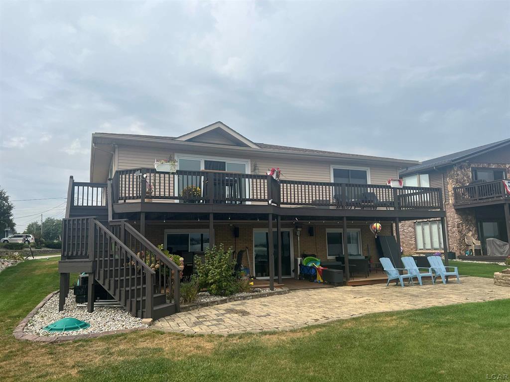 Beautiful lakefront ranch with a stunning big lake view of private all-sports Lake Columbia. This four-bedroom, two-bath, walkout with nearly 2,480 square feet of finished living area offers two kitchens, one on the main floor and another on the lower level. The open floor plan provides great space for lake living at its best with scenic views from your deck or lake-level patio. Flat yard access directly to the lake.  Sandy bottom shoreline for swimming, fishing, or just relaxing.  Newly finished LVT floors throughout the basement and original hardwood in main floor bedrooms.