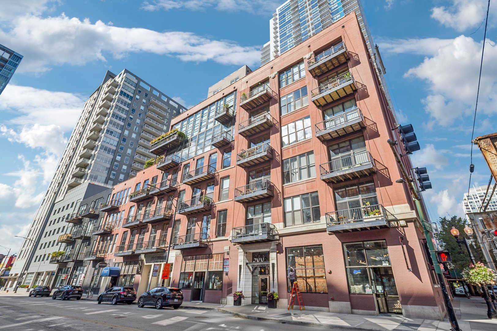 Located in a boutique elevator building in an ideal River North location, this highly sought after 2 bed, 2 bath corner loft is a showstopper! Enjoy walls of windows showcasing sweeping east and north city views. The open-concept floor plan offers generous living space with two fully enclosed, oversized bedrooms. Additional highlights include in-unit laundry, a cozy gas starter/wood burning fireplace, and fantastic internal storage and a seperate (large) room in the basement. Enjoy outdoor living with a private south-facing balcony plus panoramic city views from the building's rooftop deck-perfect for summer sunsets! Unit come with it's own PRIVATE ROOFTOP DECK.  Authentic loft details include exposed brick walls, gorgeous timber ceilings, and hardwood floors, all bathed in natural light.   The building offers secure fob access, an updated lobby, elevator access, Unbeatable location-steps to the Loop, public transportation, East Bank Club, the Riverwalk, restaurants, shops, parks, and with easy access to I-90 & I-94. Parking Spot is included the price.