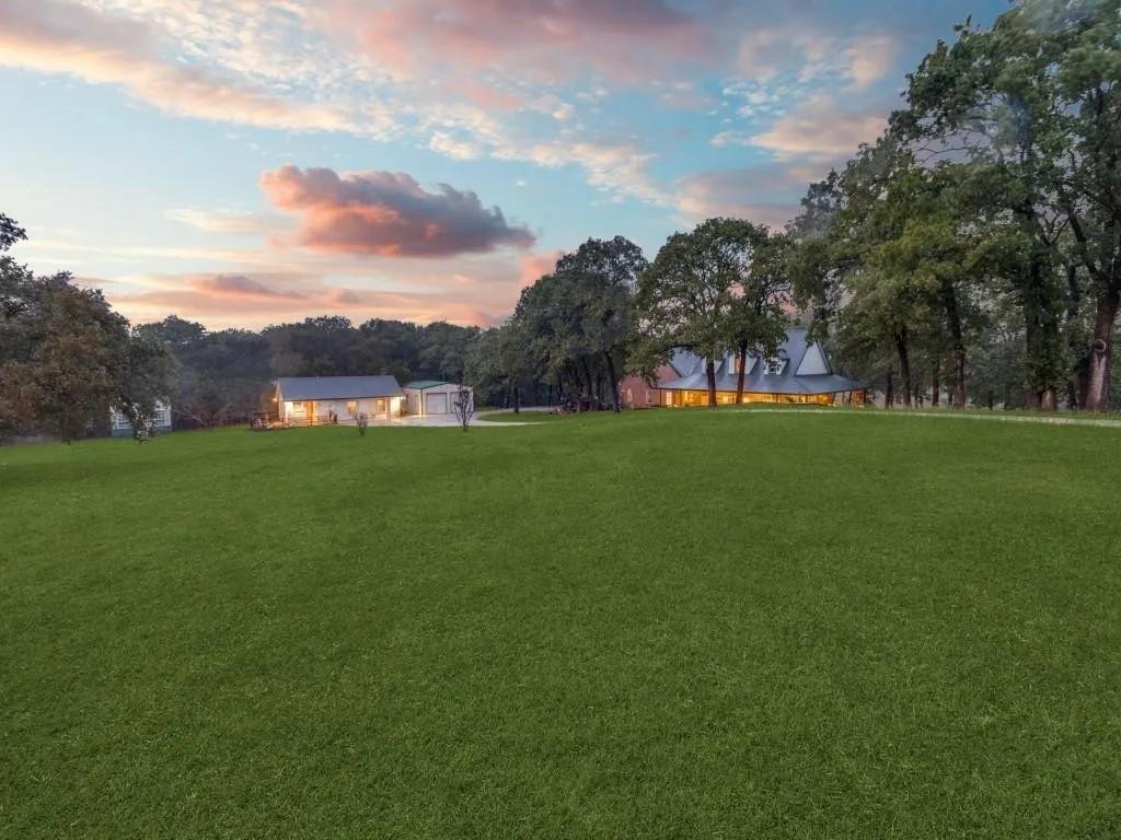 The most wonderful ranch resort home that is perfectly situated on just shy of 22 acres. Exploring this property is such a delight. Every inch of this custom built home shows off the craftsmanship that went into the details. Modern living and open floor plan for entertaining family and friends with a gourmet kitchen featuring high end commercial grade appliances, eat at kitchen island, granite countertops, loads of cabinet storage. Vaulted ceilings in great room w cozy fireplace. Luxurious and private primary w ensuite bath. Large laundry, oversized garage. Enough about the gorgeous home lets talk about the grounds.Wrap around porch with emphasis on outdoor and backyard enjoyment.HUGE deck w fireplace overlooks magnificent pond, professionally landscaped, just out the front door is a pretty and restfull water feature. Guest home has full kitchen w large bath,workshop, greenhouse,Covered RV parking storage shed.Rock Creek Resort Golf Club truly in your backyard.Lake Texoma minutes away.