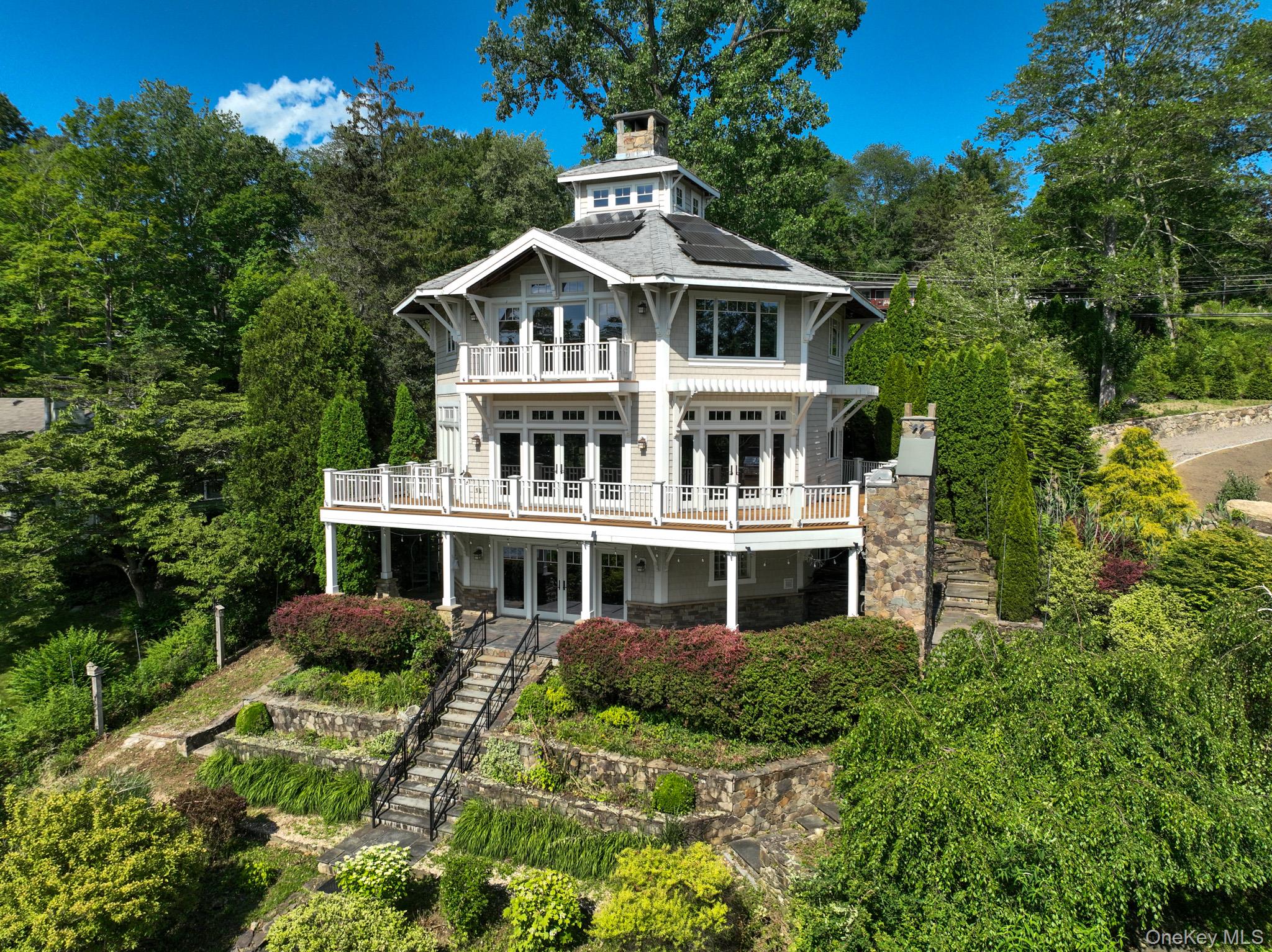 Welcome to a unique sanctuary that marries expert design with masterful craftsmanship in every detail. This lakefront home greets you with a welcoming lodge-style entry, leading to an open and flexible floor plan that epitomizes resort-style living. Architectural highlights include exposed structural wood beams, vaulted ceilings, walls of windows, French doors, reclaimed dark wood flooring, and magnificent stone fireplaces, all contributing to the rustic charm of this sophisticated country residence. Inside, the bespoke home boasts a true chef's kitchen, spa-like bathrooms, and an exquisite built-in custom bar. Enjoy the serenity and beauty of Truesdale Lake from multiple vantage points: the wrap-around deck on the main level, the patio with a wood-burning fireplace and pizza oven on the lower level, or the balcony off the primary suite. The exterior is equally captivating, featuring tiered French gardens with a mid-level terrace and stone walls that enhance the sublime views of the lake. The lakeside lawn includes a stone fire-pit and a transformed shed bar, perfect for entertaining. This eco-friendly property also offers radiant heat floors throughout, a state-of-the-art air filtration system, an automatic standby generator, and many other special features. Located within the sought-after Katonah-Lewisboro school district, this well maintained home is a rare opportunity you don't want to miss! Additional Information:  Amenities:Steam Shower,Storage,ParkingFeatures:2 Car Detached,