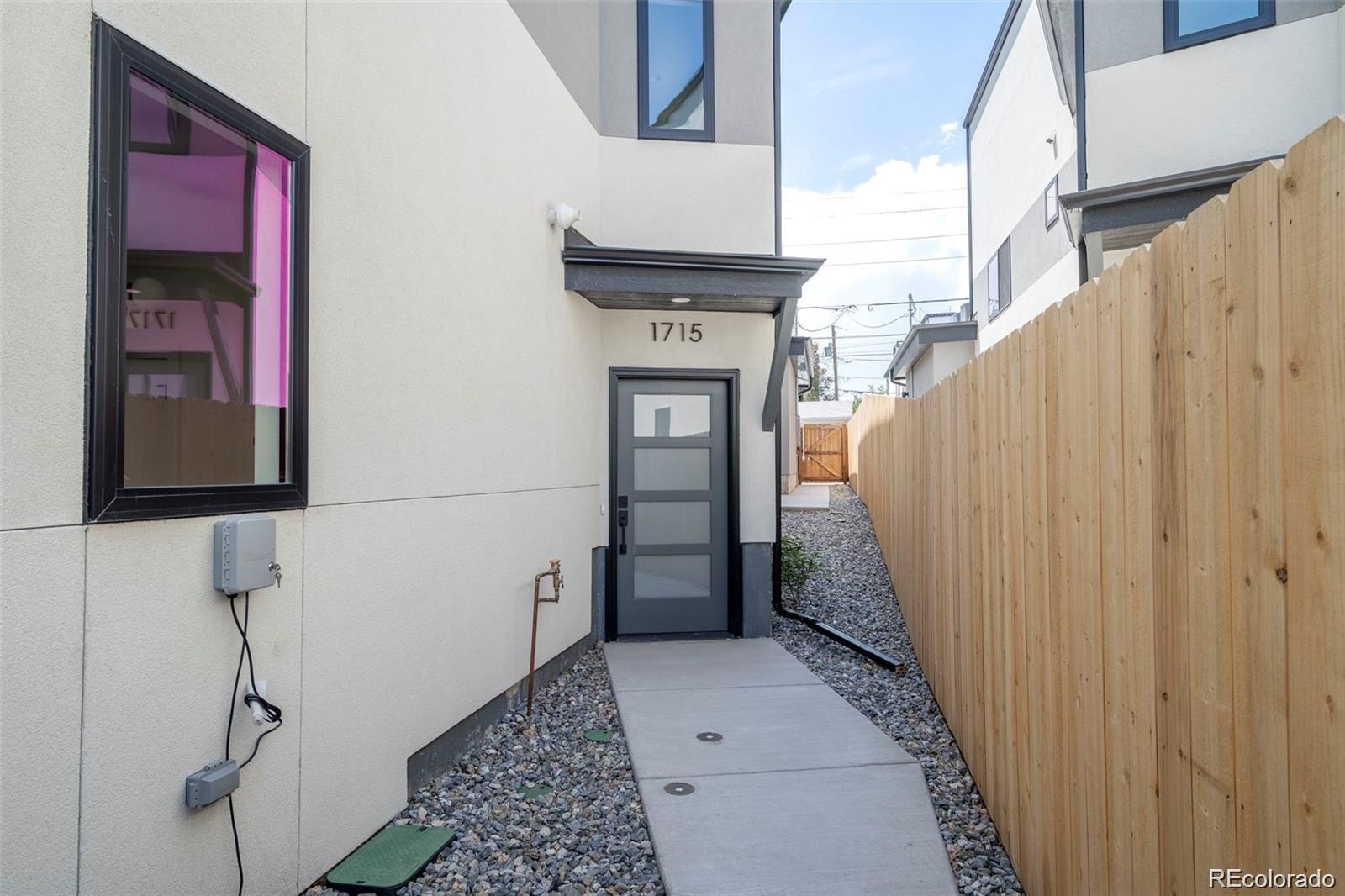 Tucked away in the heart of Denver’s most energetic corridor — a brand-new contemporary townhome with no HOA, located is just a five-minute walk to Empower Field and minutes to Sloan’s Lake. Combining modern architecture with thoughtful functionality, this home delivers the best of both worlds: city convenience and the freedom of independent ownership.

The main floor features an open-concept layout that flows that flows seamlessly from the living room to the kitchen and dining area — perfect for entertaining with family and friends or relaxing after a long day. The designer kitchen showcases quartz countertops, custom cabinetry, a large island, and stainless-steel appliances, all thoughtfully arranged to maximize space and functionality.

Upstairs, the primary suite serves as a private retreat with its own balcony overlooking the neighborhood — the perfect place to enjoy your morning coffee or unwind after a game at the stadium. The spa-inspired ensuite bath includes dual vanities, a glass-enclosed shower, and elegant finishes. Two additional bedrooms, a full bath, and an upstairs laundry room complete the upper level, blending practicality with comfort.

The finished basement adds even more flexibility with a spacious family room and/or a guest bedroom with a full bath with a stylish wet bar — perfect for hosting friends, setting up a home gym, or creating a media room. Every detail of this home was crafted to elevate modern living while maintaining a warm, livable feel.

Located near Empower Field, Sloan’s Lake, and Denver’s best restaurants and breweries, this townhome puts you at the center of it all — without the burden of HOA fees or restrictions. Whether you’re catching a game, taking a sunset walk by the lake, or entertaining at home, this townhome offers the perfect balance of design, freedom, and lifestyle.
Don’t miss your chance and schedule your private showing today and experience the best of modern city living.