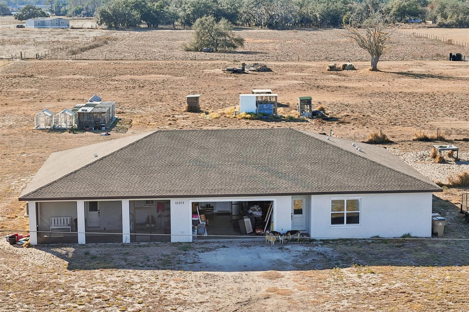 MORE PHOTOS TO COME!! MOTIVATED SELLER-ALL OFFERS WELCOME!  Looking for country living within driving distance of urban lifestyle. This home is perfect. The 2023 built, almost 5 acre fenced property, in the town of Clermont, Florida has it all. A beautiful 3000 square foot multi generational home can be a great option for someone looking to have a private apartment for a family member or it can easily be made into duplex. The main house has 2 bedrooms and 2 bathrooms with a large kitchen that boast an amazing island for chefs of all types. The kitchen opens to a grand great room for relaxing, entertaining or holidays with family members and guests. You can access the private screen porch from the kitchen and family room and look onto the beautiful landscape of the back of the property. The master suite is an owners dream with views of the property.The mother in law suite has 1 bedroom and 1 bathroom with a full kitchen and large living room. This unit of the home also has a private screened porch in the back and a private entrance and screened porch in the front of the home.Included with the home are 2 chicken coops and multiple concrete slabs for future accessory buildings, barns or sheds. There is also a separate fenced pasture area to separate animals. Minor finishes and repairs required. Property has been appraised.Drive times to areas of interest: Less than an hour to Airport and Downtown Orlando, East and West Coast beaches about 2 hours, Disney 30 minutes