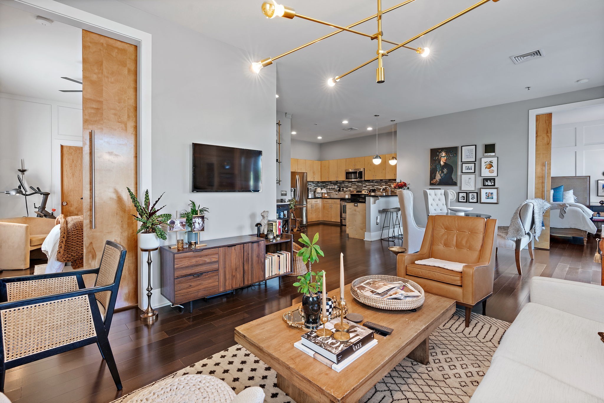 Light pours into this incredibly rare 2nd floor flat with 10' ceilings! Primary bedroom features HUGE walk in closet, private en suite bathroom, & separate vanity with abundant storage. Kitchen and bathrooms have granite counter tops & natural maple cabinets. Each room is lit by gorgeous designer light fixtures and all paint has been updated. Enjoy hardwoods throughout, separate utility room with W/D (2020, remain!), and private balcony! In a world of identical bland grey condos being built, this unit features stunning oversized 9ft natural wood sliding bedroom doors and cozy design choices that make the home extra special. Situated on the same block as Urban Juicer, Hattie B's, Zanies, and Publix! You truly never need to leave the neighborhood, but if you want to, I65 and I440 access are just blocks away. 4 mins to 12 South and The Gulch. Gated community with elevator and (2) reserved parking spaces!  Don't miss this unbeatable price to reside the heart of Vibrant 8th Ave!