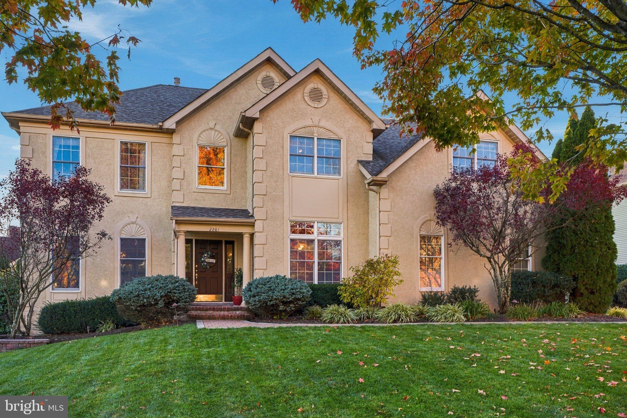 Welcome to 2281 Sunrise Way, a gracious 4 bedroom, 3.1 bath home in Jamison’s Estate of Bucks County Country Club neighborhood, served by the Central Bucks School District. Offering over 3,600 square feet of above-ground living space plus a finished walkout basement, this beautiful home combines impressive architectural details, generous gathering spaces, and an inviting outdoor retreat. Mature landscaping frames the entrance, where a soaring two-story foyer and sweeping staircase create a memorable welcome. Gorgeous hardwood floors, decorative moldings, and abundant natural light bring warmth and character to the main level. The living and dining rooms provide an elegant backdrop for entertaining, with oversized windows and classic detailing. At the heart of the home, the kitchen features abundant cabinetry, stainless steel appliances, double wall ovens, and a center island with seating. The adjoining breakfast area opens to the spectacular two-story great room, where a marble fireplace, tall windows, and an upper-level overlook create a striking yet comfortable gathering space. A separate office with French doors and custom built-ins offers a handsome setting for working from home. Upstairs, the spacious primary suite features a tray ceiling, a separate sitting room, a walk-in closet, and an en suite bath with a double vanity, soaking tub, and separate shower. Three additional bedrooms complete the upper-level accommodations. The finished walkout basement adds exceptional flexibility, with space for movie nights, recreation, exercise, and hobbies, along with a full bathroom. A sound system and upgraded electrical further enhance the home’s amenities. Outdoor living is equally inviting on the expansive rear deck, with ample room for dining and lounging, a hot tub for unwinding, and mature evergreen screening that creates a lush backdrop when playing catch in the side yard. From lively summer gatherings to quiet evenings under the stars, this is a space designed to be enjoyed. With its generous proportions, beautiful hardwood floors, and versatile living spaces, 2281 Sunrise Way offers an exceptional opportunity to enjoy life in this coveted Jamison neighborhood. Schedule your showing today!