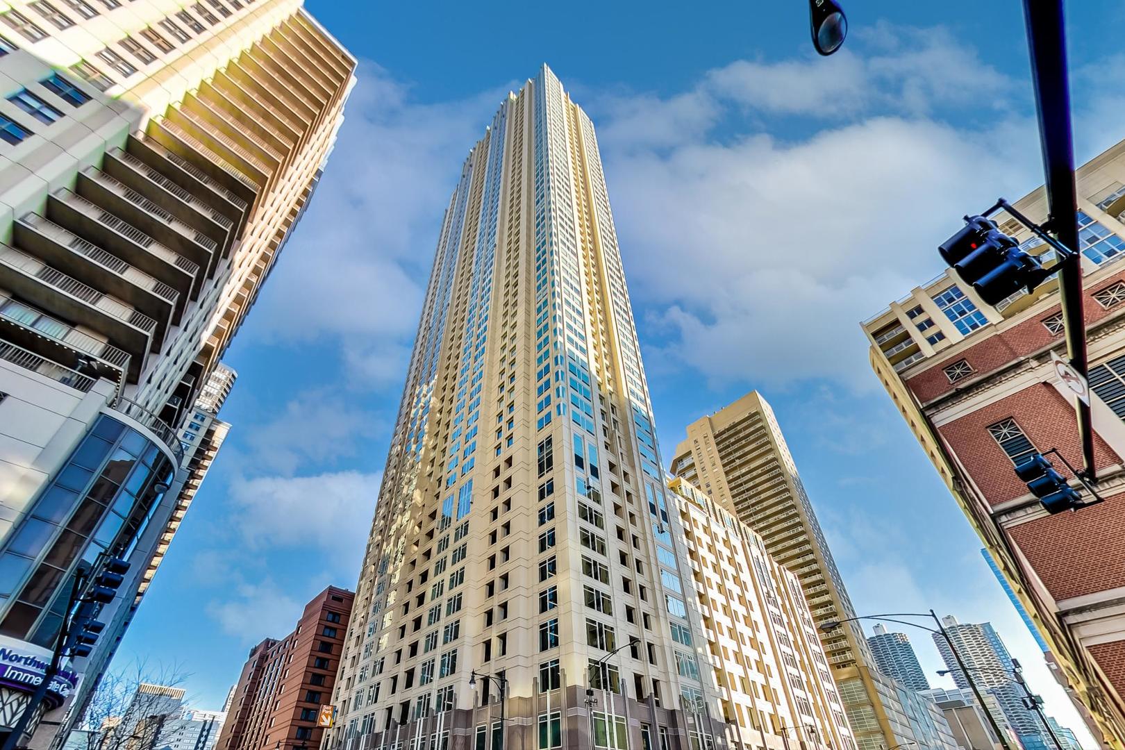 This 2 bedroom, 2 bathroom home soars above the city in the heart of Downtown Chicago's vibrant River North neighborhood! This is a rare corner unit offering dramatic North and West exposures with dramatic windows that flood the home with natural light. From sunrise glow to sunsets, enjoy unobstructed skyline and river views from every angle.  The open-concept kitchen is designed for both chefs and entertainers, featuring a large island, 42" maple cabinetry with abundant storage, and a seamless flow into the living space.  Perfect for gatherings with a backdrop of city lights.  Residents enjoy the highest quality lifestyle in a full-service amenity building with an outdoor pool, state-of-the-art fitness center, 24-hour door staff, media room, storage, dry cleaning, and in-unit package delivery. Assessments cover all utilities except electricity. Full size washer/dryer in unit.  Extra storage included.  Steps from Chicago's finest dining, shopping, nightlife, and cultural destinations, this is a must see.  Welcome home!