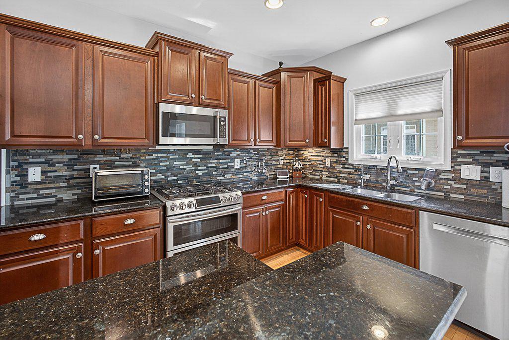 Rare opportunity to live in the heart of West Broad Village within walking distance to Whole Foods, Trader Joe’s, HomeGoods, and more. Built in 2013, this townhome offers 3 spacious bedrooms and 3.5 bathrooms with thoughtful updates throughout. The entry level features a versatile bedroom with a full bath and updated flooring (Dec 2021), perfect for guests or a private home office. The main level showcases an open-concept layout with a bright living and dining area, powder room, and access to both front and rear elevated patios. The kitchen is beautifully updated with stainless steel appliances (2020), including a WiFi-enabled gas range with double ovens, granite countertops, premium backsplash, large island, and a Café convection oven/microwave (2022).Upstairs, two primary suites each offer walk-in closets and private full baths, along with updated flooring (Dec 2021). The main suite includes a front-facing balcony and a fully upgraded shower. A brand new roof (2026) adds peace of mind.Enjoy skyline views from your own rooftop terrace perfect for entertaining, as well as access to the community clubhouse with a gym, pool, and theater. Just steps away, you’ll find a neighborhood park and a scenic paved trail through the trees leading to Short Pump Park. Complete with a rear-entry two-car garage, this home offers the perfect blend of lifestyle, location, and low-maintenance living.