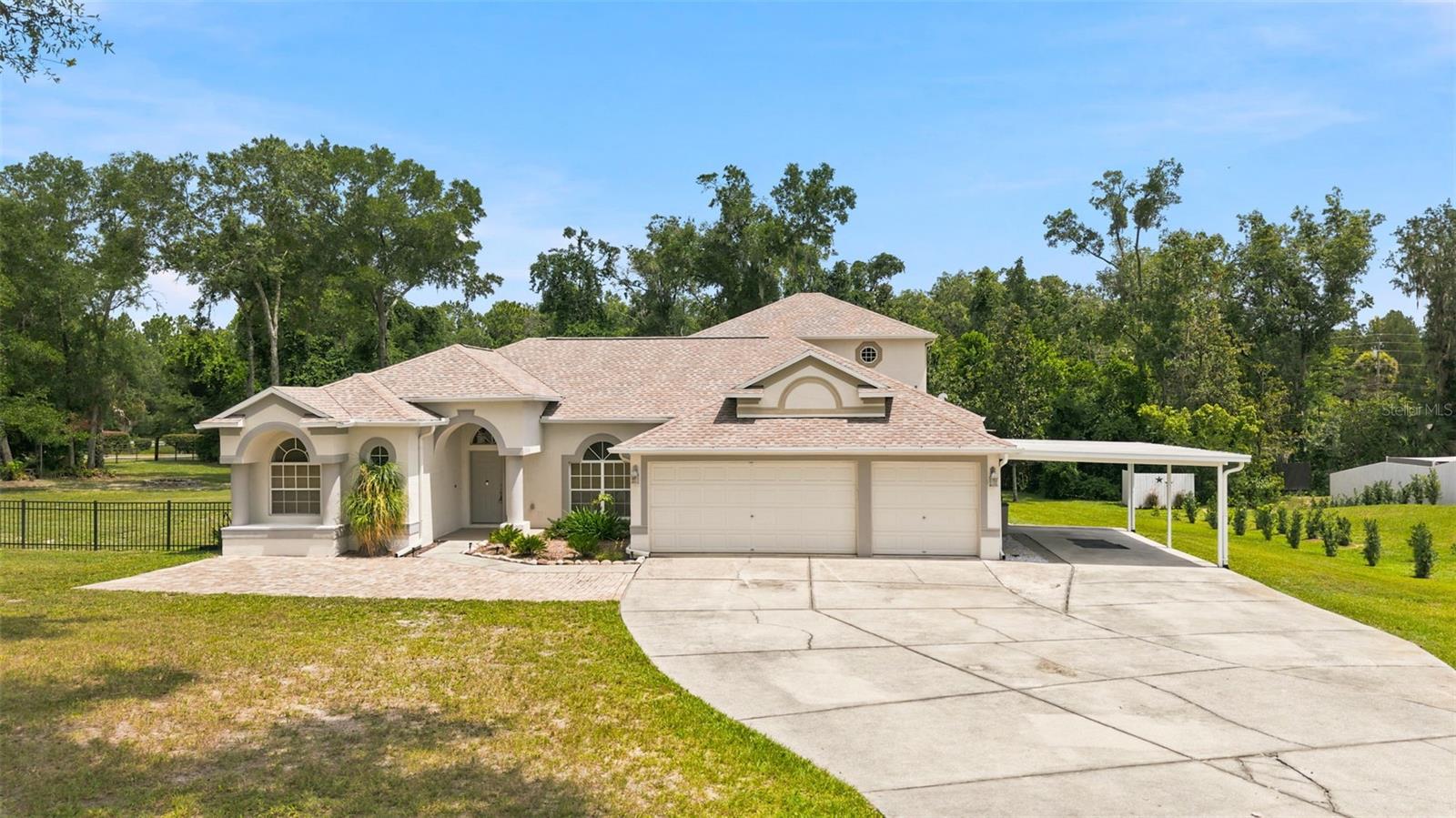 Virtually Staged. ** BRAND NEW ROOF MAY 2026  **  Welcome to Dry Creek Estates, an exclusive community of just 38 homesites where privacy, space and the Florida lifestyle come together. Occupying a generous 1.14 acre homesite, this impressive 4 bedroom, 4 full bathroom home offers 2,994 square feet of thoughtfully designed living space with room to spread out both inside and out.Designed for both everyday living and entertaining, the home features a formal living room, a spacious family room and an expansive kitchen that truly serves as the heart of the home. You'll love the oversized island, abundant cabinetry, generous counter space and exceptional storage. The laundry room is conveniently located just off the kitchen and includes built in cabinets and a utility sink.   The split bedroom layout provides privacy for everyone. The primary suite occupies its own wing of the home, while the 4th bedroom is tucked away down its own hallway at the rear of the house, making it ideal for guests, multigenerational living or a private home office.Upstairs, you'll find an impressive 600sqft loft complete with its own en suite bathroom. Whether you're looking for a guest suite, media room, game room, second living area or another option for your home office, this flexible space creates endless possibilities.Out back is the true Showstopper. 3 sets of sliding glass doors and numerous windows fill the home with natural light while providing beautiful views of the pool from multiple rooms. Outside, you'll find a 15 x 40 pool surrounded by an expansive 24 x 50 paver deck and highlighted by a beautiful stone waterfall. A separate covered 12 x 28 patio offers the perfect place for outdoor dining, relaxing or entertaining. The dedicated pool bathroom keeps wet feet out of the main living areas and adds convenience for family and guests.The partially fenced yard provides plenty of room to play, garden or simply enjoy the outdoors. Gather around the fire pit on cool evenings, take advantage of the additional storage offered by both a large utility building with a roll up door and an extra storage shed that is perfect for lawn care or pool equipment. Additional highlights include a whole home water softener system, an attached 3 car garage, an additional carport and a BRAND NEW ROOF (2026).One of the best parts of this home is its location. Living in Dry Creek Estates means enjoying everything Florida's Nature Coast and Adventure Coast have to offer. Spend your weekends watching the mermaids, kayaking crystal clear springs, paddling gorgeous rivers, hiking scenic trails, fishing, boating, scalloping or exploring nearby state parks and wildlife preserves. It's the perfect balance of country living and convenient access to shopping, dining, schools and everyday amenities.If you've been looking for room to spread out, a backyard made for entertaining, an unbeatable location and a home that truly embraces the Florida lifestyle, this is one you'll want to experience in person.
