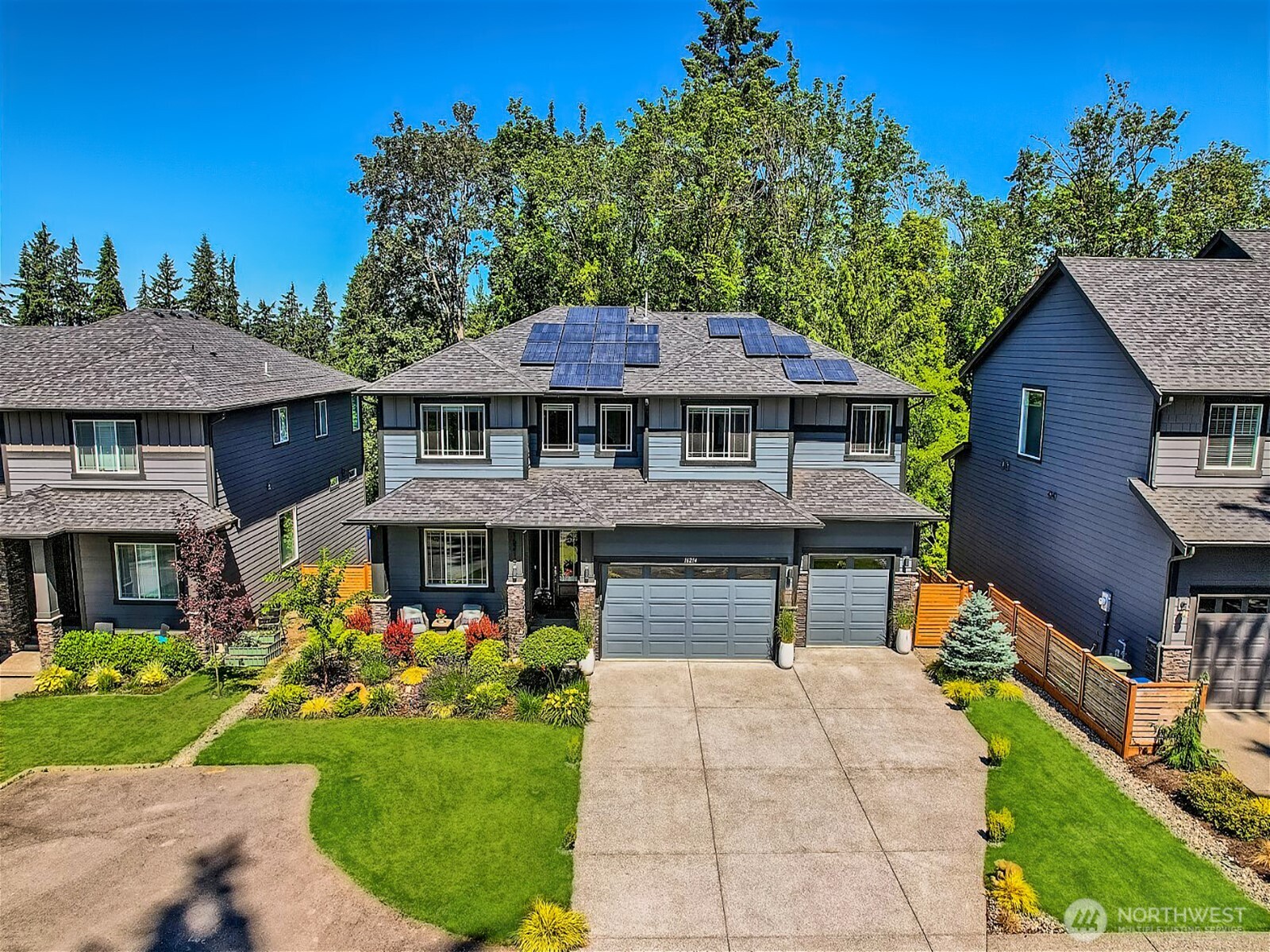 This 2021 modern craftsman is everything! Better than new construction with $100k in custom upgrades. You won't find a lovelier or friendlier street to live on in Kenmore. Top-rated Northshore schools. Great room w/ fireplace & private veranda overlooking a peaceful tree line. Regular sightings of NW wildlife! Kitchen w/ luxury range, commercial fridge & butler pantry. Main floor suite/office + full bath. 2 Rec rooms! Endless possibilities for the 1,100 sqft MIL w/ living rm, bed, bath, kitchenette & patio. SPAN solar panels. HE furnace & tankless H2O w/ UV sterilization systems. AC + whole home humidifier. Large, level lot is meticulously landscaped, front/rear sprinklers. 3 Car garage, EV outlet. Minutes to Bothell, Lk WA & golf courses.