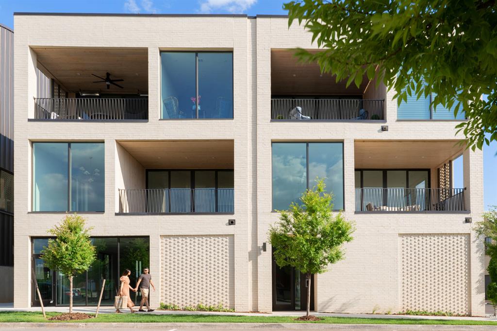 This custom-designed top-floor flat offers three bedrooms, including two primary suites, and abundant storage, setting a new standard for modern living in Wheeler District. The curated layout maximizes space and functionality, blending sophistication with comfort. Expansive windows flood the home with natural light and frame unobstructed views, while hardwood floors and geothermal heating and cooling add both style and sustainability. The chef’s kitchen features a quartz island, upgraded appliances, and seamless flow into the living and dining areas. From here, step out to a large covered veranda with glass openings, an inviting space for morning coffee, evening meals, or simply taking in the view of Wheeler District and Downtown Oklahoma City. Elevator access and an oversized private garage provide ease and convenience, while the prime location keeps you steps from Wheeler District’s pool, park, retail, and dining. Perfect for someone seeking the ease of one-level living in Wheeler District and the convenience of a true lock and leave lifestyle, this home combines thoughtful design with a vibrant community setting.