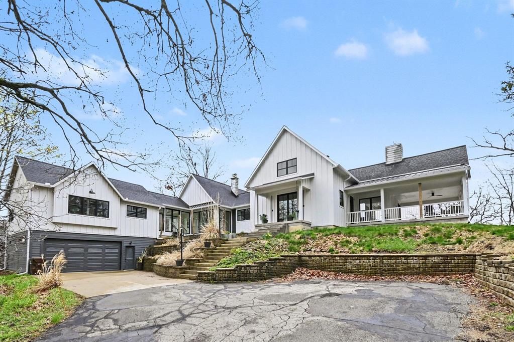 This newly completed custom home (2024) on Cavanaugh Lake, captures something that is exceptionally difficult to replicate--over 140 feet of frontage, panoramic lake views from every room, and a level of scale and versatility rarely found on the water.From the moment you enter, a full wall of glass draws you directly to the lake. The elevated setting provides a sweeping vantage point--expansive, unobstructed, and constantly shifting with the light, culminating each evening in vivid, colorful sunsets reflected across the water.The main level spans over 3,600 square feet, designed for both effortless daily living and elevated entertaining. The kitchen and great room flow seamlessly, anchored by a fireplace and framed by the view. A walk-in butler's pantry with additional sink enhances functionality, while a private office offers a quiet, dedicated workspace.Positioned above the entry, the open loft overlooks the great room and frames views of both the lake and front of the home.Currently used as an artist studio, it offers a flexible space equally suited for a library, lounge, or creative retreat.The primary suite is positioned to fully embrace the setting, complete with a generous bath, walk-in closet, and its own washer and dryer--creating a true private retreat within the home.Outdoor living is equally intentional, offering multiple distinct spaces to take in the lake. An expansive covered patio extends directly from the great room, creating a natural gathering space. In addition, a large composite deck and lower-level patio provide even more options for entertaining or quiet moments, all leading down to the dock--perfect for ending the day lakeside as the sun sets in striking color.The lower level adds over 2,600 square feet of living space, including three bedrooms, a theater room, second fireplace, expansive gathering area, kitchenette, and extensive storage for all your lake essentials.And just when you think this property can't get any better, a feature that truly sets this property apart: a separate, f