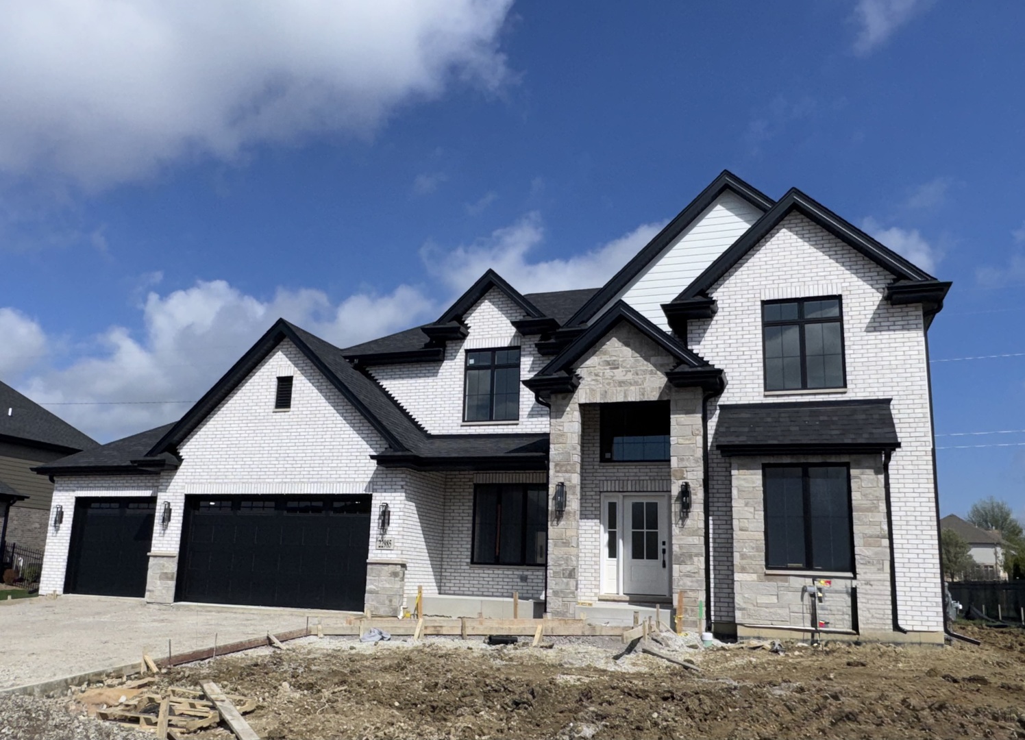 Welcome to your dream home! This nearly completed open 2-story floor plan is a masterpiece of design and luxury, ready for occupancy in 3 short weeks. Crafted by Elite Builders, this 2-story home showcases the finest in quality custom construction, boasting 3733 sq ft of spacious living. Step inside and be greeted by the expansive open floor plan, ideal for modern living and entertaining. With 4 bedrooms and 3 1/2 baths, including an office that can easily double as a 5th bedroom, this home offers versatility to suit your lifestyle. The 18 x 18 primary bedroom is a retreat in itself. Pamper yourself in the deluxe 13 x 11 bathroom, complete with a freestanding modern rectangular soaker tub, double sinks, and a separate oversized step-in shower. Plus, never worry about storage with the generously sized walk-in closet equipped with a closet organizer system. There is plenty of room to grow with the extra deep full basement, featuring roughed-in plumbing for a future bathroom. Stay comfortable year-round with two furnaces (one with humidifier for first floor level), ensuring optimal climate control throughout the home. Enjoy outdoor living on the 15x14 concrete patio, perfect for summer barbecues and relaxing evenings under the stars. Both neighbors have the decorative wrought-iron style fence, so it will be a breeze to complete the fence for your yard.  Additional features abound, including Andersen thermopane windows, 2x6 exterior construction for enhanced structural strength and insulation, quartz countertops, a cozy fireplace, vaulted ceilings, 2-story family room, 9' basement ceiling, custom Riverton cabinetry, and deluxe Frigidaire Gallery stainless appliances.There is plenty of storage and room for bikes and tools in the 32'x24' garage. Don't miss your chance to own this impeccable home, where luxury meets functionality in every detail. Act quickly if you want to pick the carpet! It will be ordered soon! Landscaping allowance credit of $15,000 now being offered.