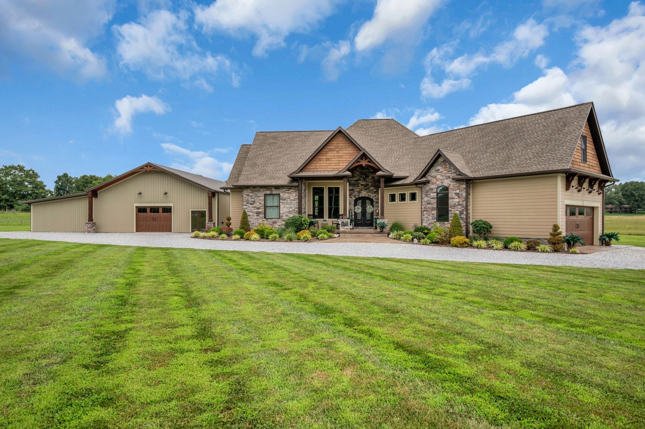 This home makes a statement! A rare opportunity to own 152± acres in the heart of Dickson, just minutes from downtown and approximately two miles from shopping, restaurants, and everyday conveniences. This custom-built estate offers the perfect combination of luxury, privacy, and endless possibilities.The 3-bedroom, 3.5-bath home features an open floor plan with soaring vaulted ceilings, exposed wood beams, a stunning floor-to-ceiling stone gas fireplace, and a chef's kitchen complete with custom cabinetry, stainless steel appliances, and a hammered copper farmhouse sink. An office provides the ideal work-from-home space, while the main-level primary suite offers a spa-inspired bath with a soaking tub, tiled shower, dual vanities, and spacious his-and-her walk-in closets. Upstairs, you'll find a large bonus area with one room perfect for entertaining and another that could easily serve as a fourth bedroom, home gym, hobby room, or additional office. The encapsulated crawl space includes a dehumidifier for added efficiency and peace of mind. Home offers a tankless water heater. Outdoor living is designed for entertaining with a spacious covered patio, additional open patio, and a custom stone outdoor kitchen featuring a built-in KitchenAid natural gas grill. Beautiful wood ceilings accent both the front and rear porches, while stamped concrete, wrought iron doors, and professional landscaping complete the home's impressive curb appeal.The matching 40' x 60' shop includes a full bath with tiled shower, laundry area, walk-in closet, and a finished flex room ideal for a guest suite, office, or workout space.The property features multiple ponds, established food plots, and abundant wildlife, making it ideal for hunting, recreation, farming, or simply enjoying the beauty and privacy of Middle Tennessee. Properties of this caliber rarely become available, making this a truly exceptional opportunittionality, and an unmatched lifestyle. see mls 3251340 for land only