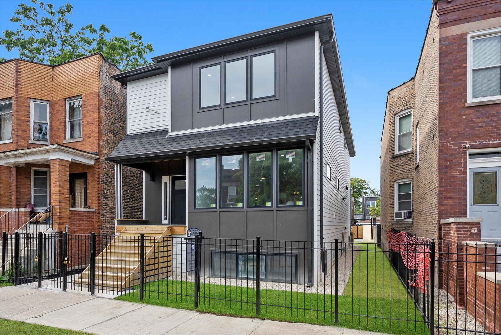 Stunning NEW CONSTRUCTION in Humboldt Park featuring 7 bedrooms and 3.5 baths. Contemporary curb appeal with Hardie board siding, large windows, and an inviting front porch leads into an open-concept main level with hardwood floors, high ceilings, and a bright living area with sleek fireplace. The chef's kitchen showcases a large island, quartz countertops, stainless steel appliances, and walk-in pantry, flowing into the dining space for seamless entertaining. A main level flex bedroom/office and stylish half bath complete this floor. Upstairs, the primary suite has heated flooring along with a spa-like bath with double vanities. Secondary bedrooms are generously sized, and a 2nd floor laundry adds convenience. The fully finished basement offers an in-law arrangement with 2 bedrooms, full bath, wet bar, and second laundry area is ideal for extended family or guests.  Additional highlights include, tankless water heater, modern lighting, oversized rooms, outdoor deck with fenced yard, and a two-car garage. Located in the heart of Humboldt Park near the 207-acre park with lagoons, walking paths, and cultural landmarks. Enjoy authentic dining, local cafes, and colorful murals along Paseo Boricua, with easy access to public transit and bike paths.  Schedule your private showing today! This home is a must see!
