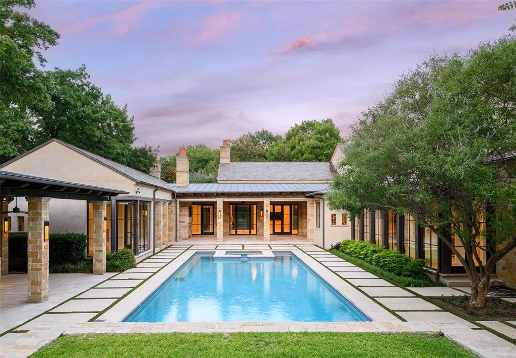 Behind a gated entrance and a long, private drive, this extraordinary 2.4-acre estate offers one of Dallas’ most secluded and captivating settings. Designed by renowned SHM Architects and masterfully built by Rosewood Custom Homes, the 9,420-square-foot residence is a timeless composition of stone and stucco, expansive windows, and crowned by a distinguished slate roof.Thoughtfully crafted for elevated everyday living and memorable entertaining, the residence offers five-bedroom suites, five full baths, two powder baths, an executive study, a private fitness room, and an underground wine cellar with an intimate tasting room. A light-filled studio overlooking the backyard provides exceptional flexibility as an artist’s retreat, playroom, hobby space, or creative workspace.The resort-inspired heavily landscaped grounds are equally impressive, with a sparkling oversized pool, outdoor pavilion, multiple stone elevations, pathways, and two separate grilling stations. Uniquely, the estate enjoys expansive lawns both in front of and behind the residence, creating an uncommon sense of space while preserving exceptional security and privacy. Dramatic landscape and architectural lighting transform the estate after sunset, illuminating mature trees, stone elements, and the grounds in a captivating evening display. A four-car garage completes the property.Rich in architectural pedigree and enduring craftsmanship, this remarkable estate presents a rare opportunity for a new owner.
