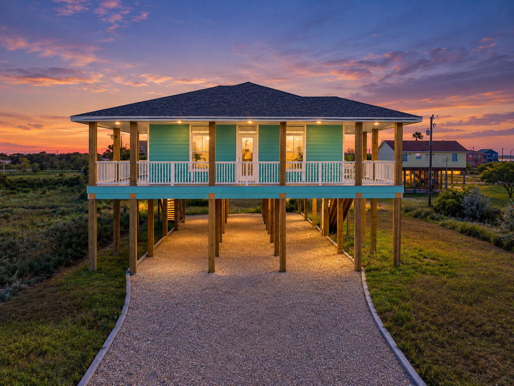 Coastal Charm Meets Newer Construction in Holiday Beach! From the moment you arrive at 130 Glen Oak Lane, this inviting 3 bedroom 2 bathroom 1750 square foot home is made for relaxed Holiday Beach living. Two stairways provide convenient access to the home, where an expansive covered porch wraps across the front and along one side of the home. Complete with ceiling fans and plenty of space it's the perfect spot to unwind, entertain, and enjoy the coastal breezes in the shade. Step inside to a spacious open-concept floor plan highlighted by a vaulted ceiling that gives the living area a bright, airy feel and an easy flow into the beautifully appointed kitchen. Experience just the right touch of coastal style with gorgeous granite countertops, custom cabinetry, and a generous island offering additional workspace, extra seating, and a natural gathering place for family and friends. The spacious primary suite offers a comfortable retreat and a beautifully finished bathroom featuring a custom-tiled walk-in shower. Two additional guest bedrooms and a well-appointed hall bath provide ample space for family and guests. The home features a large utility room with expansive storage including a private exterior door leading out to the deck and one of the two staircases. On the ground level, the covered area adds even more usable space for entertaining, relaxing, and storing all the toys that come with the coastal lifestyle—all your fishing gear, kayaks, beach equipment, and more. Whether you're looking for a full-time coastal home, a weekend getaway, or your own place on the Coast, 130 Glen Oak Lane offers newer construction, inviting indoor and outdoor living spaces, and the laid-back lifestyle that makes Holiday Beach such a special place to call home.
