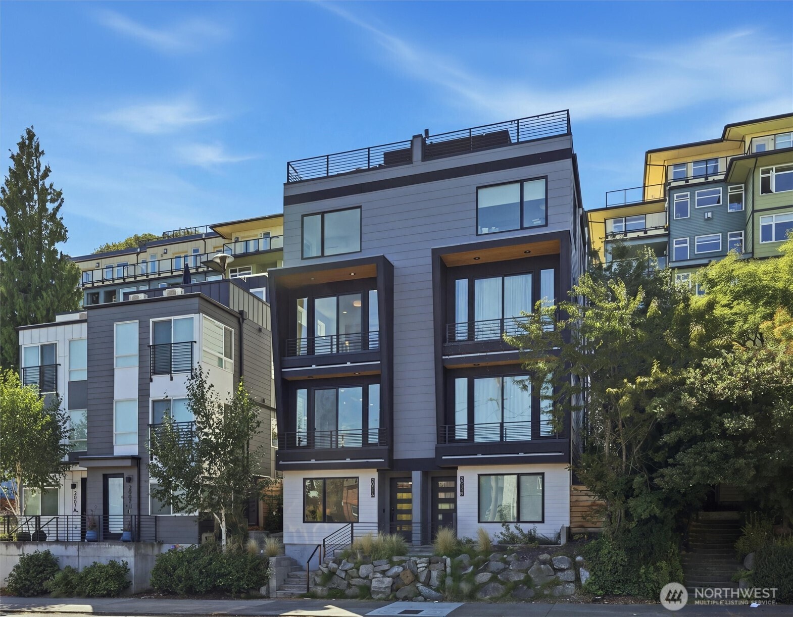 LAST HOME! Right in Westlake, where everything feels close but never crowded, this home puts you minutes from Lake Union, SLU, and the café-lined edges of Queen Anne. Your private rooftop deck sets the tone—lake views, city lights, and summer nights that stretch a little longer. Inside, the layout is open, bright, and built to connect. Three bedrooms offer flexibility, while the main level flows seamlessly for both everyday living and hosting. The kitchen is clean and modern with a social feel, anchored by a sleek island and quality finishes. A floating open-tread staircase adds a sharp architectural moment, and a bonus flex space easily adapts to WFH or a home gym. Zoned heating and A/C keep things comfortable year-round, with covered EV-ready parking, WA/DR included, engineered hardwoods, and smart storage throughout. A refined take on urban living, right where Westlake hits its stride. **Preferred lender rate buydown, 1% off todays current rates + lender credit to cover buyer closing costs and no fees on future refinance**