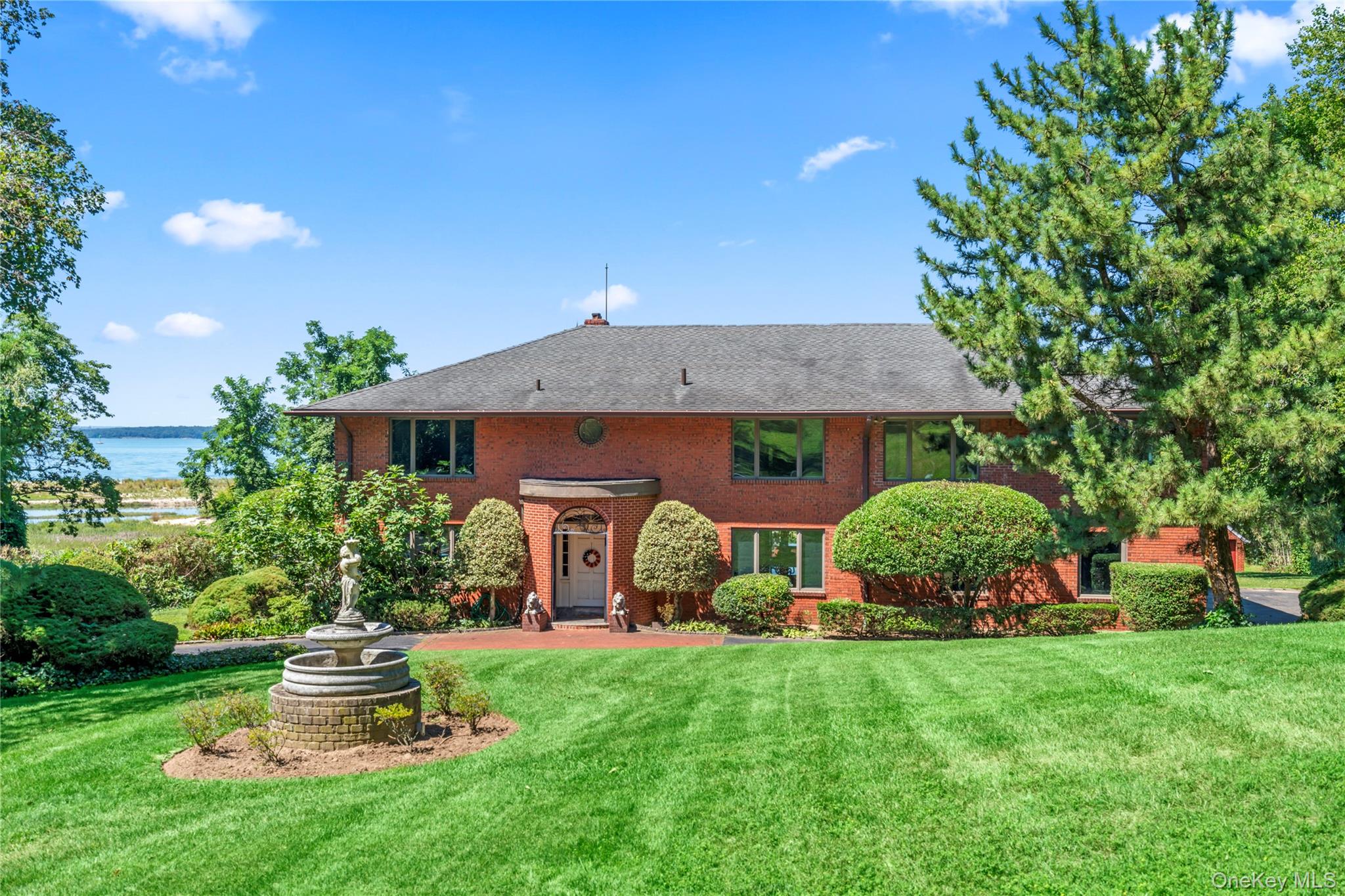 Sunset Beach - A Private Coastal Retreat on Long Island Sound. Step from your backyard into the pristine waters of the Sound — where coastal luxury meets everyday living. Welcome to Sunset Beach, an enchanting 10-room brick estate nestled on five private, fully fenced acres along one of Long Island’s most coveted waterfronts.