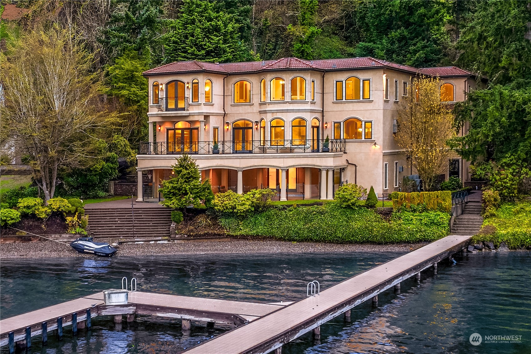 A distinctive Medina home set on 115 feet of prime no-bank Lake Washington shoreline. This residence offers breathtaking views of the lake & downtown Seattle from a serene, private setting. Ideal for all seasons, it features a gourmet chef’s kitchen, entertaining spaces & a formal dining & living room. A grand spiral staircase leads upstairs to the primary bedroom with stunning lake views, 3 additional bedrooms & a sophisticated office. The downstairs game room includes a wet bar, wine room & ensuite bedroom, plus access to the covered patio with a pool. The 150+ foot dock is perfect for watercraft activities & provides a picturesque backdrop. An exceptional opportunity to move in or update & personalize this Medina waterfront property.