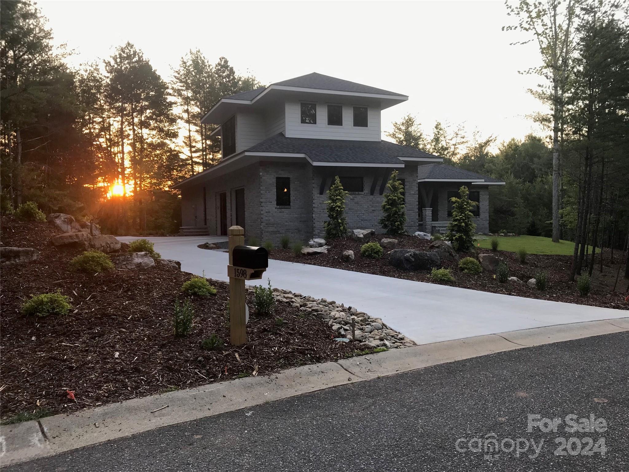 Clean lines and light filled, this contemporary styled home is the perfect place to call home.  Spacious and open living and dining spaces. Simple iron mantle over the gas fireplace.  Large sliding doors exit onto the covered and screened porch where you'll want to spend  all your time.  Kitchen has an abundance of horizontal white oak cabinetry as well as a walk in pantry that blends seamlessly into the kitchen with continuous quartzite counters, lots of open shelving and an additional refrigerator.  Split bedroom plan gives privacy to the primary suite with double sinks, large zero entry shower and soaking tub.  Side entry door allows for a half bath, generous sized drop zone mudroom and stairs to the finished bonus area above the garage. Oversized 2 car garage with sink and electric vehicle charging port. Located in Southpointe with community pool, deeded boat slip and Dry Creek walking trails.  Just 15 minutes to Morganton and minutes to Fonta Flora Trail & Lake James State Park.