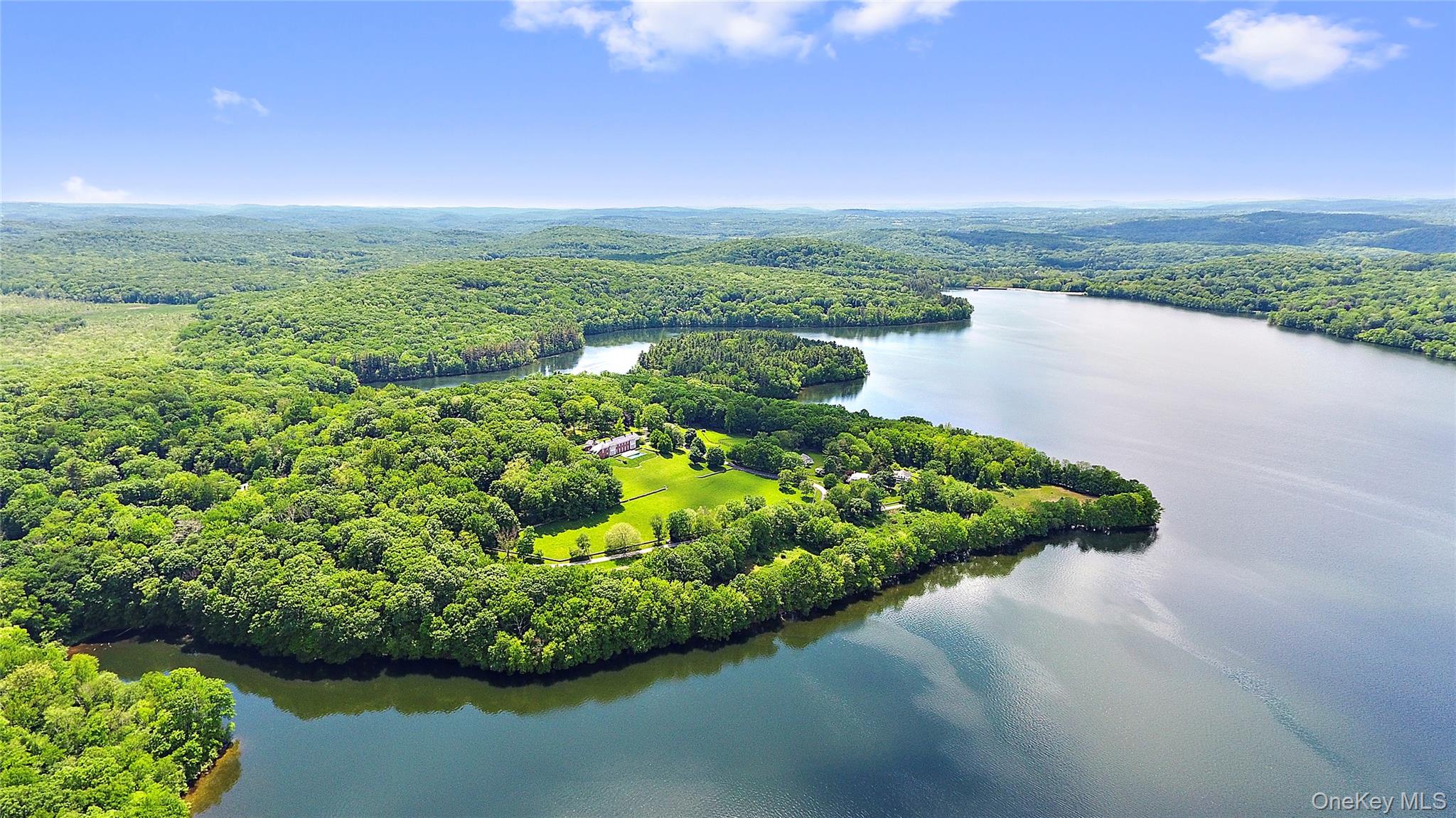 The spectacular Titicus Reservoir and over nine acres are the backdrop to this stunning architectural gem.  Completed in 2001 and substantially renovated in 2024, the the house is conceived as open concept. The primary entry hall and all of the public spaces are framed by walls of large windows and doors that face the incredible 180 degree water view.  French doors lead out to a sparkling 60-foot infinity edge pool that overlooks the expanse of lawn and the reservoir beyond.  12-foot ceilings, six fireplaces, gleaming refinished wide plank floors, radiant heated floors, and extensive millwork and built-ins are just a few of the luxury elements incorporated into the home. The kitchen, open to the family room, is centered on two islands finished in Calcutta marble.  The primary bedroom is outfitted with partner bathrooms and two walk-in dressing rooms.  A first floor guest suite is privately located in its own wing. Just over one hour's drive from New York City, the property is conveniently located within three miles of the charming hamlet of Purdys, the Metro North Train Line and Exit 7 of Interstate 684.  Come live the dream in beautiful North Salem!
