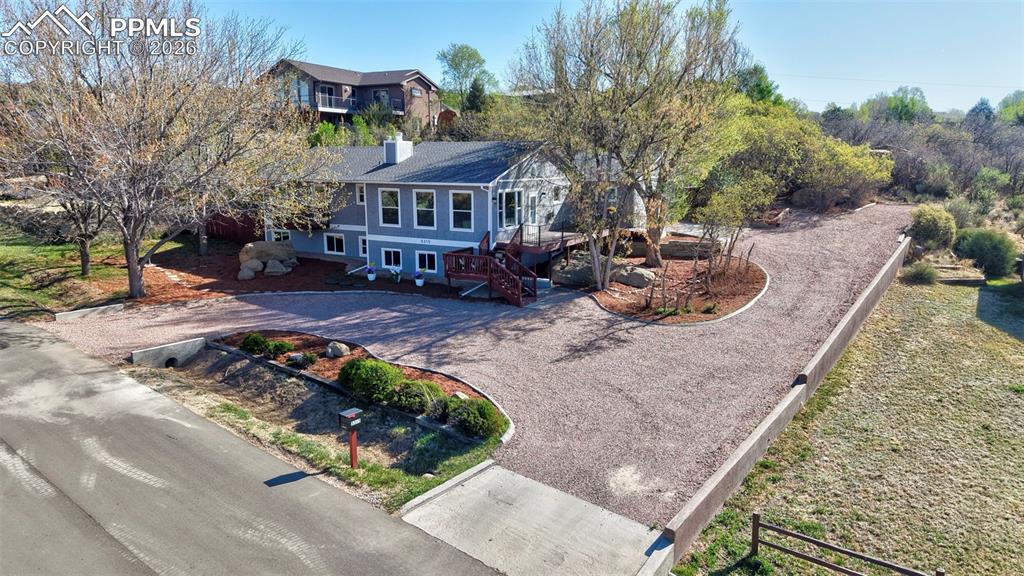 Welcome to this beautifully remodeled 5 bedroom, 3 bath home located in Park Vista Estates, where open space, natural beauty and modern living come together seamlessly. Set in one of Colorado Springs’ hidden gems, this unincorporated neighborhood offers half+ acre sized lots, no streetlights or sidewalks, and no HOA—delivering the freedom, privacy, and peaceful country feel you’ve been searching for. From the moment you step inside, the home has a sleek, modern feel, filled with natural light from large windows that perfectly frame Colorado’s mountains for stunning sunrises and sunsets. The open and inviting layout highlights main-level living with a thoughtful design that feels bright, airy, and connected to the outdoors at every turn. The bright kitchen featuring new cabinetry, quartz countertops, stainless steel appliances, a spacious island, and a large pantry is designed with cooking in mind and a space any home chef will appreciate. Step outside your dining room walk-out to find a truly unique backyard retreat including a large covered deck, multiple seating areas and a dedicated area for hot tub with existing outlet; all great for entertaining, relaxing or simply enjoying Colorado’s great outdoors. The setting continues with dramatic natural rock formations giving the feel of The Garden of the Gods right in your own backyard with frequent wildlife visitors—all set within a quiet, peaceful environment. The lower-level’s large family room with walkout adds incredible flexibility with a private entrance, making it ideal for multi-generational/family living arrangements or a perfect setup for small business owners needing separate access and space. From the fresh exterior and interior paint, to the new lighting, flooring, and trim, this home is everything you've been looking for and more. Low-maintenance landscaping, new washer and dryer, and newly installed 2026 A/C complete this exceptional, move-in-ready property.