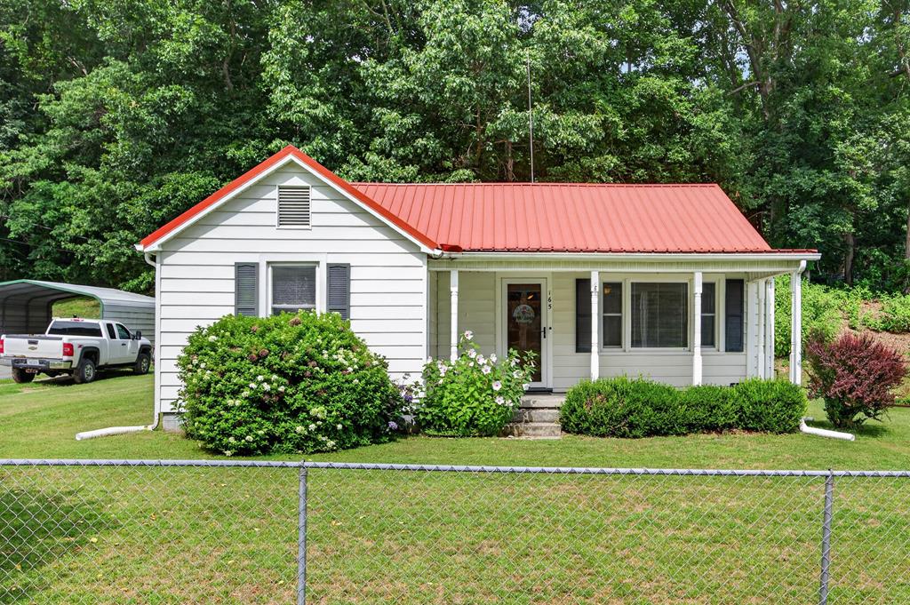 Welcome to 165 Blue Sky Drive! This adorable cottage sits a short distance from the Town of Wytheville, and is ready to call you its new owner! Upon stepping inside, you'll be delighted to find that this home captures the original charm that everyone loves! Main floor highlights include a spacious living room perfect for gathering with loved ones, an eat-in kitchen with ample counter space for the chef in the house, 2 generously sized bedrooms, as well as 1.5 bathrooms! The unfinished basement is a blank canvas ideal for storage, and comes equipped with a French drain/sump pump system installed by Fortress Foundation! As you venture outside, you'll find a metal roof offering long-term durability, a partially fenced yard perfect for kids or fur babies at play, and a covered front porch begging to host your morning coffee! In addition to being move-in ready, this charming home is around the corner from Interstates 81 & 77 ensuring an easy commute no matter the destination! Don't miss out on this amazing opportunity! Schedule your private showing today!
