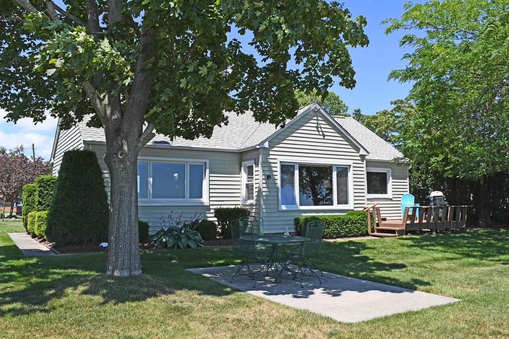 Tawas Bay waterfront home on 60' of sandy frontage! This three bedroom 1.75 bath home has lot's of character! The interior and exterior have been well maintained over the years. The interior boast knotty pine providing that nostalgic up north feeling! New shingles on the garage and bunk house in 2020, and the home's shingles were replaced in 2019. This property sits off the main highway and is located with easy access to the new bike path that takes you to Tawas Point. The beach is sandy with a 10'x60' deck over the seawall. There is lots of storage space in the 24'x24' garage for all of your water toys as well! Several golf courses are in the area and thousands of acres of state and federal land are available for your exploration.