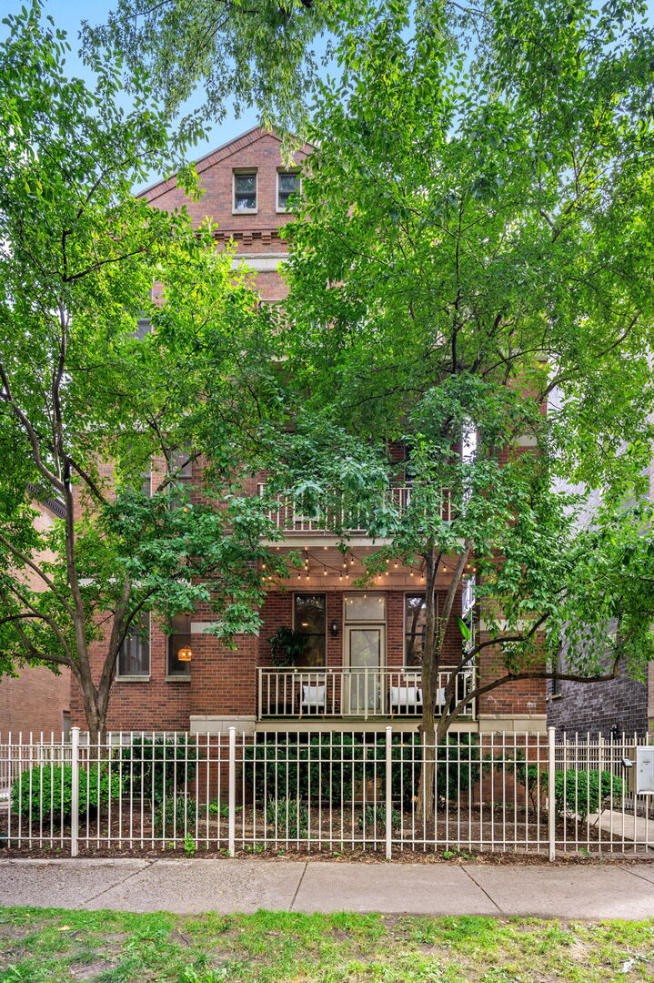 Welcome to this extra-wide Andersonville 3-bedroom, 2.5-bath duplex down, set in an intimate 4-unit building. It sits on a quiet street in beautiful Andersonville. With soaring 10-foot ceilings, graceful archways, and windows on three sides, the home is flooded with natural light across both levels and offers the feel of a single-family residence. The showstopper kitchen has been completely remodeled, featuring brand-new stainless steel appliances, modern cabinetry, stylish backsplash, quartz countertops, and an oversized island perfect for entertaining. A separate formal dining room and living room are connected by a striking two-sided fireplace, while hardwood floors throughout the main level add warmth and elegance. Downstairs, the newly designed primary suite boasts a spa-caliber bathroom with a steam shower, soaking tub, and dual vanity. Both the second full bath and half bath have been fully updated, as has the spacious laundry room, now complete with full-size front-load machines and a utility sink. All three bedrooms are thoughtfully situated on the same level. Two private outdoor spaces extend the living area, and garage parking is included.  Perfectly located neat the lakefront, CTA buses and trains, Carmen play lot, and all of Andersonville's beloved shops and restaurants, this home truly blends modern comfort with neighborhood charm.