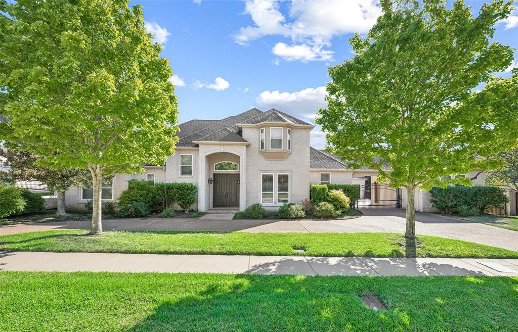 Situated in Caldwell Creek, 7005 Orchard Hill Court offers 5 bedrooms, 4.1 baths, 5,393 SF, a pool, and a spa. A circular drive, mature landscaping, and gated driveway create an inviting arrival, while the spacious interior offers a versatile layout. Rich wood floors welcome you into the home and run through the formal dining room and multiple main living areas, complemented by crown molding and abundant natural light. The kitchen features granite countertops, breakfast bar seating, and extensive cabinetry. An adjoining breakfast area includes a built-in planning desk and direct patio access, while the nearby living room is anchored by a fireplace surrounded by substantial custom built-ins. Privately positioned on the main level, the primary suite offers a sitting area and a spacious ensuite bath with dual vanities, a garden tub, a large glass-enclosed walk-in shower, and a walk-in closet. Two additional bedrooms are located downstairs, including one that could easily function as a second primary suite with an ensuite bath, separate tub, walk-in shower, and oversized closet, providing valuable flexibility for a variety of living arrangements. Upstairs, the generous living spaces continue with an expansive bonus room, a game room with built-ins, and an additional flexible area with a wet bar, well suited for a media room, hobby space, or additional lounge. Two secondary bedrooms and a bath complete the upper level. The backyard offers plenty of room to relax and entertain with a sparkling pool and spa, covered patio, mature landscaping, and a large grassy yard. An electric gate opens to an oversized 3-car garage, a separate 4th garage, and a porte-cochere, offering exceptional parking, storage, and versatility. Located in established Caldwell Creek and zoned to Grapevine-Colleyville ISD, this property combines an expansive homesite, flexible living spaces, abundant storage, and resort-style outdoor amenities in a desirable Colleyville setting.