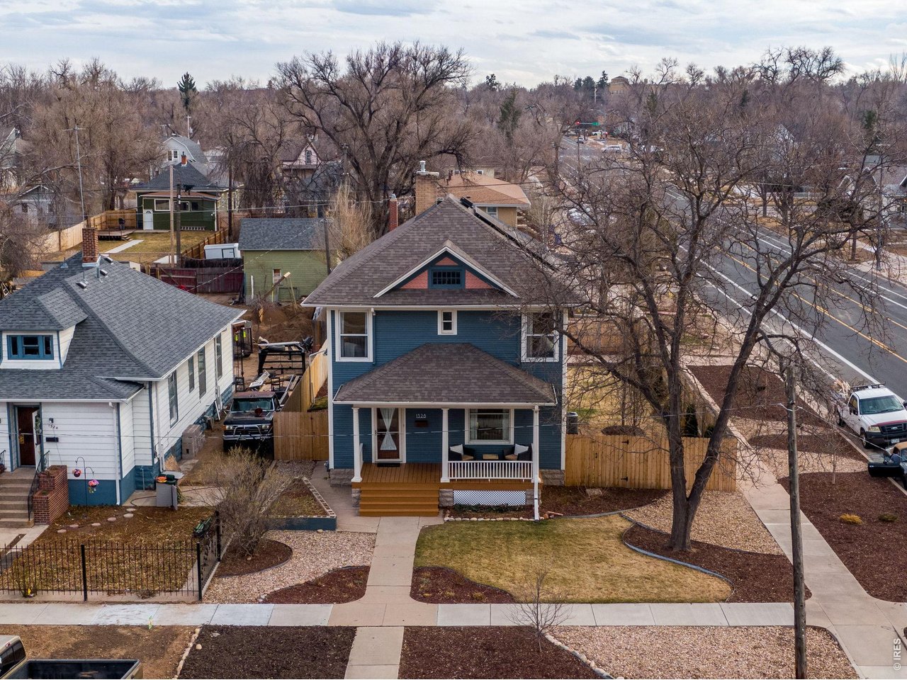 Built in 1909, this exceptionally maintained historic home has been beautifully preserved to showcase the timeless craftsmanship of the early 20th century while thoughtfully updated for modern living. The home reflects careful stewardship that honors its original character, with extensive original woodwork and trim featuring intricate hand-crafted detailing rarely found in modern homes. Throughout the home, you'll find original hardwood flooring rich with over a century of history and natural patina. Large windows fill the home with natural light, creating warm and inviting living spaces anchored by a quaint, cozy fireplace. The spacious kitchen offers abundant cabinet space, an upgraded gas range, and modern updates that complement the home's timeless feel. The luxury primary suite is truly a retreat, featuring a wall of windows that floods the room with natural light, a beautifully updated bathroom, and an enormous walk-in closet, creating an expansive and peaceful getaway. All bedrooms include walk-in closets and a newer washer/dryer are conveniently located on the second level near the bedrooms, making everyday living effortless. The home features a quaint, oversized covered front porch perfect for morning coffee or relaxing evenings, while the large private backyard is fully fenced with a newer cedar privacy fence and designed for entertaining. Enjoy a huge concrete patio, a covered back deck, all newer landscaping, and a new roof coming soon! Major system upgrades provide comfort, efficiency, and peace of mind, including central heat and air conditioning. The home also features solar panels that significantly reduce electric costs, a newer furnace, newer storm windows, newer fixtures throughout, and fresh interior and exterior paint. Additional improvements include a main water line replaced with copper piping, a newer electrical sub-panel, and a large unfinished basement offering incredible potential for future expansion, storage, or additional living space.