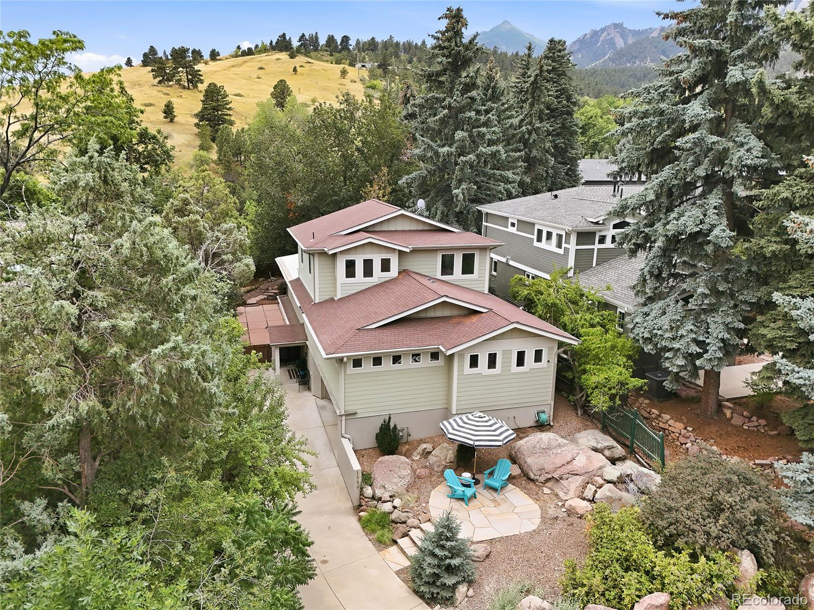 This beautifully renovated home is in the Chautauqua Park neighborhood in Boulder, an iconic historic area nestled at the bas of the Flatirons famous for cultural retreats and direct mountain trail access. It features airy and spacious living on the main level perfect for entertaining.  This house is just around the corner from the trails leading into the park.  The new kitchen has new upgraded cabinets, a Bosch range, large island, quartz countertops, under counter microwave oven. As you step outside to the patio you will have view of the top of the Flatirons.  It's the perfect place to sit and relax as you enjoy the mature garden with a cup of coffee or a quiet evening meal.  While the home has great open entertaining spaces, it also offers many private spaces in which to retreat.  The large primary suite has a spa-like 5 piece ensuite where you can escape and feel pampered.  The upper most loft level is a flex space that can be used in a multitude of ways - a private bedroom with en suite bathroom, an office, a playroom, the possibilities are endless.  The lowest level is also a self contained mini apartment with a living space, bedroom, and bathroom.  It has a garden door that leads to a large patio area in the lower level of the back garden.  Be sure to look at the oversized 2 car garage with 220 hookup.