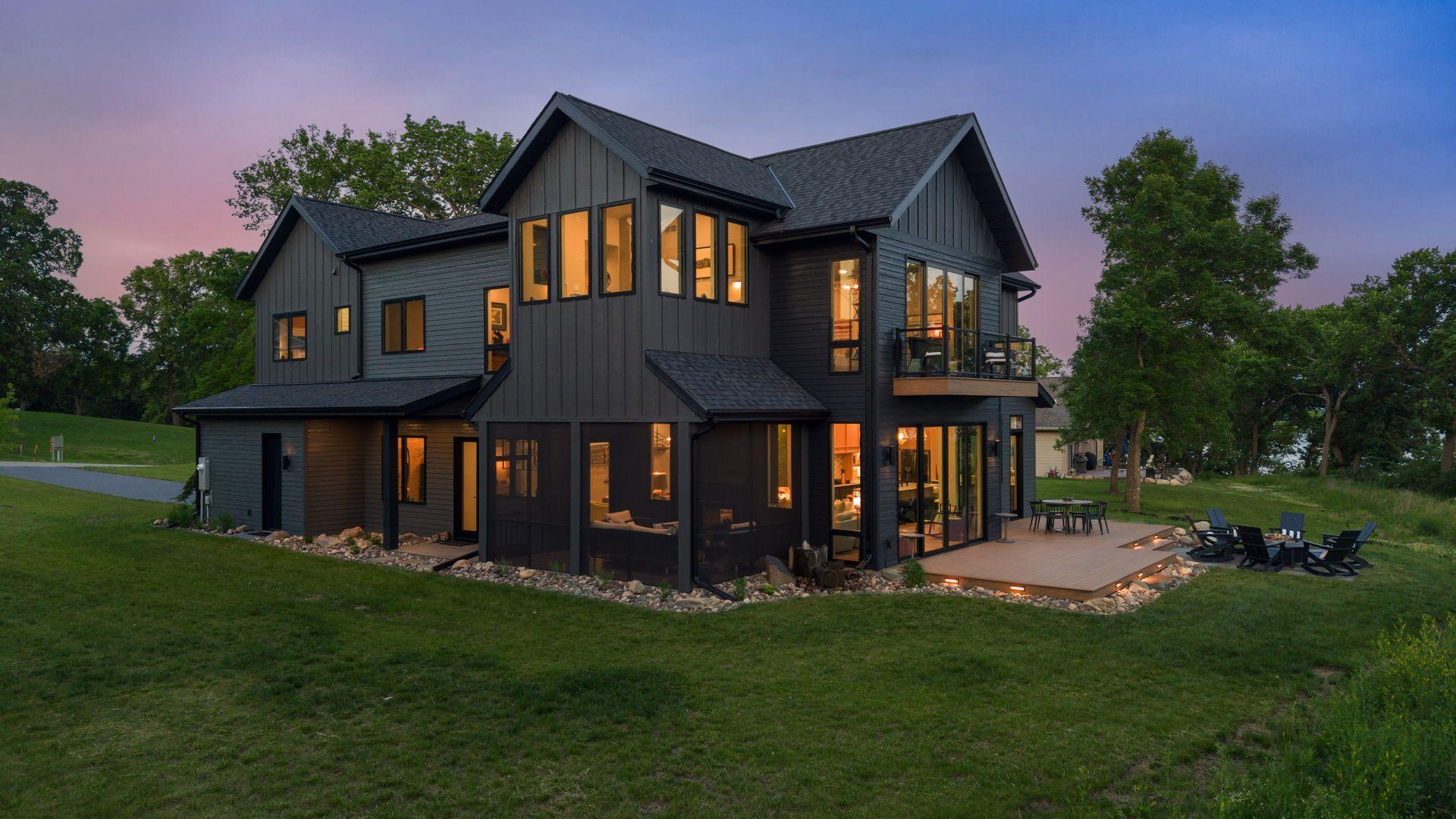 Experience effortless luxury lake living at this architecturally stunning residence overlooking Lake Koronis, one of Central Minnesota's most sought-after recreational and fishing lakes. Located just 80 miles from the western Twin Cities suburbs and minutes from charming Paynesville, this exceptional home offers the rare combination of breathtaking 180° waterfront views, modern design, and true maintenance-free ownership. Perched high on a bluff within an exclusive 14-home HOA community, the home captures sweeping views across 3,000-acre Lake Koronis and its three picturesque islands, creating a setting that feels distinctly "up north" while remaining remarkably accessible. Enjoy spectacular west-facing sunsets year-round from nearly every room. Designed by the owner and meticulously engineered and crafted, this Scandinavian-inspired modern home blends sophisticated architecture with comfortable lake living. Expansive windows, soaring ceilings, custom built-ins, designer finishes, and exceptional storage create a home that is as functional as it is beautiful. The heart of the home is an open-concept great room anchored by floor-to-ceiling Pella quad-sliding doors, seamlessly connecting the living, dining, bar, kitchen, and outdoor entertaining spaces. A chef-inspired kitchen features custom cabinetry, quartz countertops, a 10-foot island, induction cooktop, wall oven, walk-in pantry, coffee station, and stunning lake views from every angle. The main level also offers in-floor heating (including the garage), a private office, elegant screened porch with a two-sided fireplace, spacious mudroom, and thoughtfully designed entertaining spaces that flow effortlessly indoors and out. Upstairs, the primary suite serves as a private retreat with a glass balcony, wraparound windows, and a spa-inspired bath designed around panoramic lake views. Additional highlights include a dry sauna, upper-level laundry, guest accommodations, media loft, and a remarkable elevated sunroom known as the "Cozy Nest," offering unmatched views of eagles, wildlife, and unforgettable sunsets. Outdoor living is equally impressive, with a full-width composite deck, firepit patio, grilling area, basalt water feature, professional landscaping, and layered architectural lighting creating a resort-like atmosphere day and night. Residents enjoy the convenience of a professionally managed HOA that handles lawn care, snow removal, dock installation and removal, allowing more time to enjoy the lake. A dedicated boat slip, kayak storage, community swimming dock, and golf-cart access to the waterfront make lake days effortless. Just outside your door, the 16-mile paved Lake Koronis recreational trail invites biking, walking, and year-round exploration, while nearby state and county parks provide endless opportunities to enjoy Central Minnesota's rolling hills, forests, and natural beauty. This is luxury lake living reimagined-an extraordinary blend of architectural excellence, low-maintenance convenience, and one of Minnesota's most captivating waterfront settings.
