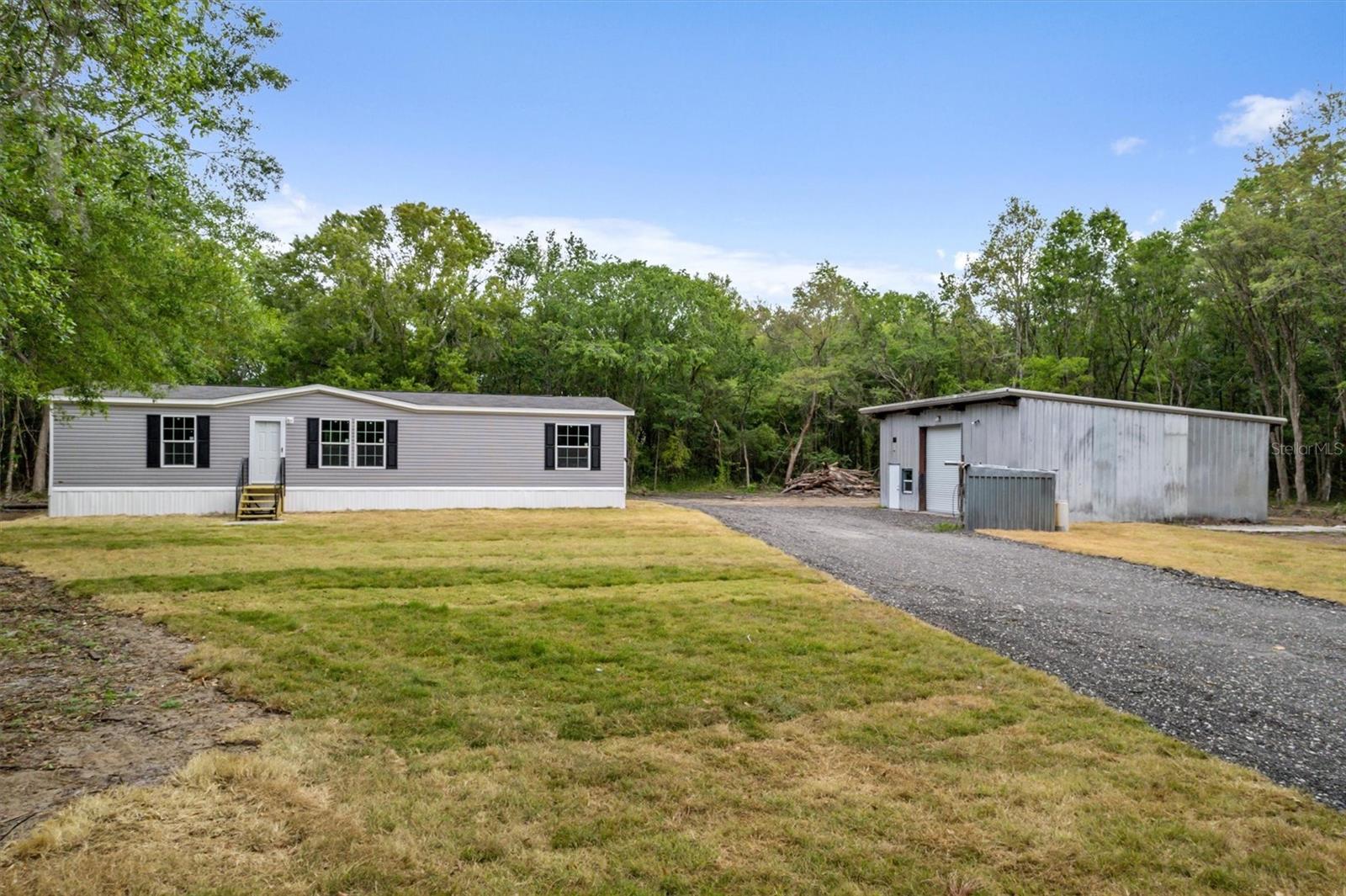 Country living with city convenience! This brand-new doublewide manufactured home sits on 1.13 acres, offering nearly 1,500 sq. ft. of living space with 3 bedrooms and 2 baths. The property features a mechanical garage with a bonus room,  a shed for extra storage, and plenty of space for all your toys.
Located about 20 minutes from Palm Coast and St. Augustine, and only 20 minutes to the beach, this home is perfect for those who love the outdoors. No HOA—bring your ATVs, boats, and RVs! Enjoy nearby trails, mudding spots, and the freedom of open space while staying close to shopping, dining, and entertainment. Don’t miss this unique opportunity!