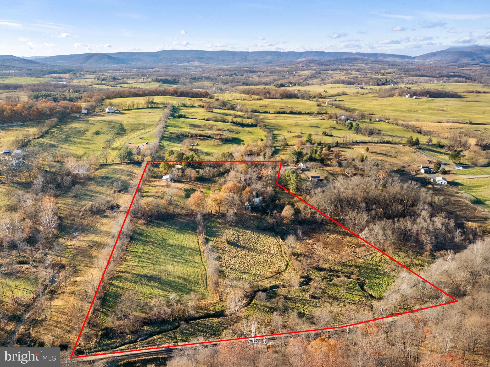 “Chattin” — 20 Acres on Lost Corner Road.  Nestled above Rectortown along scenic Lost Corner Road, “Chattin” comprises 20 acres recorded in two parcels.  The land is predominantly open pasture with two ponds, generous frontage along Chattin Run, and sweeping pastoral and mountain views.Improvements include a main residence (circa 1989), currently in need of major repair but offering substantial potential. A charming guest house (circa 1880) features 3 bedrooms, 2 baths, a studio space, and a machine shop. Additional structures include a 4-stall barn, making the property suitable for a variety of equestrian or agricultural uses. Located in a private yet highly sought-after Orange County Hunt area, this property presents a rare opportunity in a prime countryside setting.  Property offered in AS-IS condition.