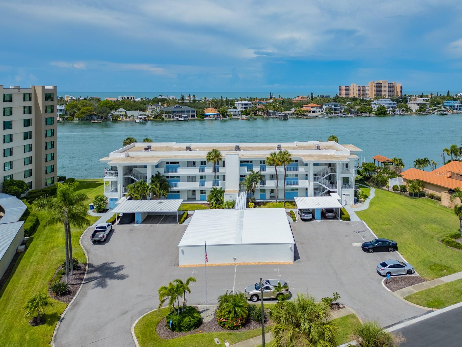 RARE GROUND-FLOOR WATERFRONT OPPORTUNITY at the quaint and beautifully maintained Sea Island North on desirable Island Estates!  The waterfront is practically your backyard! Walk directly from your unit to the community dock for morning coffee or an evening cocktail, cast a fishing line, launch your kayak, or simply watch the daily parade of dolphins and manatees. The dock area features a grill, water and electric, and you can even tie up your boat for the day. Enjoy panoramic views of Mandalay Bay and effortless waterfront living from this bright and spacious 2-bedroom, 2-bath coastal condo.  Step inside to an open, inviting floor plan featuring hurricane-impact windows and doors, beautiful engineered hardwood flooring, wood shaker cabinetry, gorgeous granite countertops, updated bathrooms, and ample storage. The Florida Room may quickly become your favorite spot—perfect for relaxing while taking in the sparkling water views and spectacular Florida sunsets.Sea Island North offers the charm of a smaller, immaculately maintained waterfront community along with all the perks of the Island Estates lifestyle. Once you're home, you may not want to leave the island! Publix, restaurants, shopping, entertainment and more are just a short walk or bike ride away. Hop aboard the Jolley Trolley for an easy ride to world-famous Clearwater Beach.Whether you're looking for a full-time residence or your own Florida getaway, this is an opportunity to enjoy the waterfront lifestyle Island Estates is known for—right outside your door!