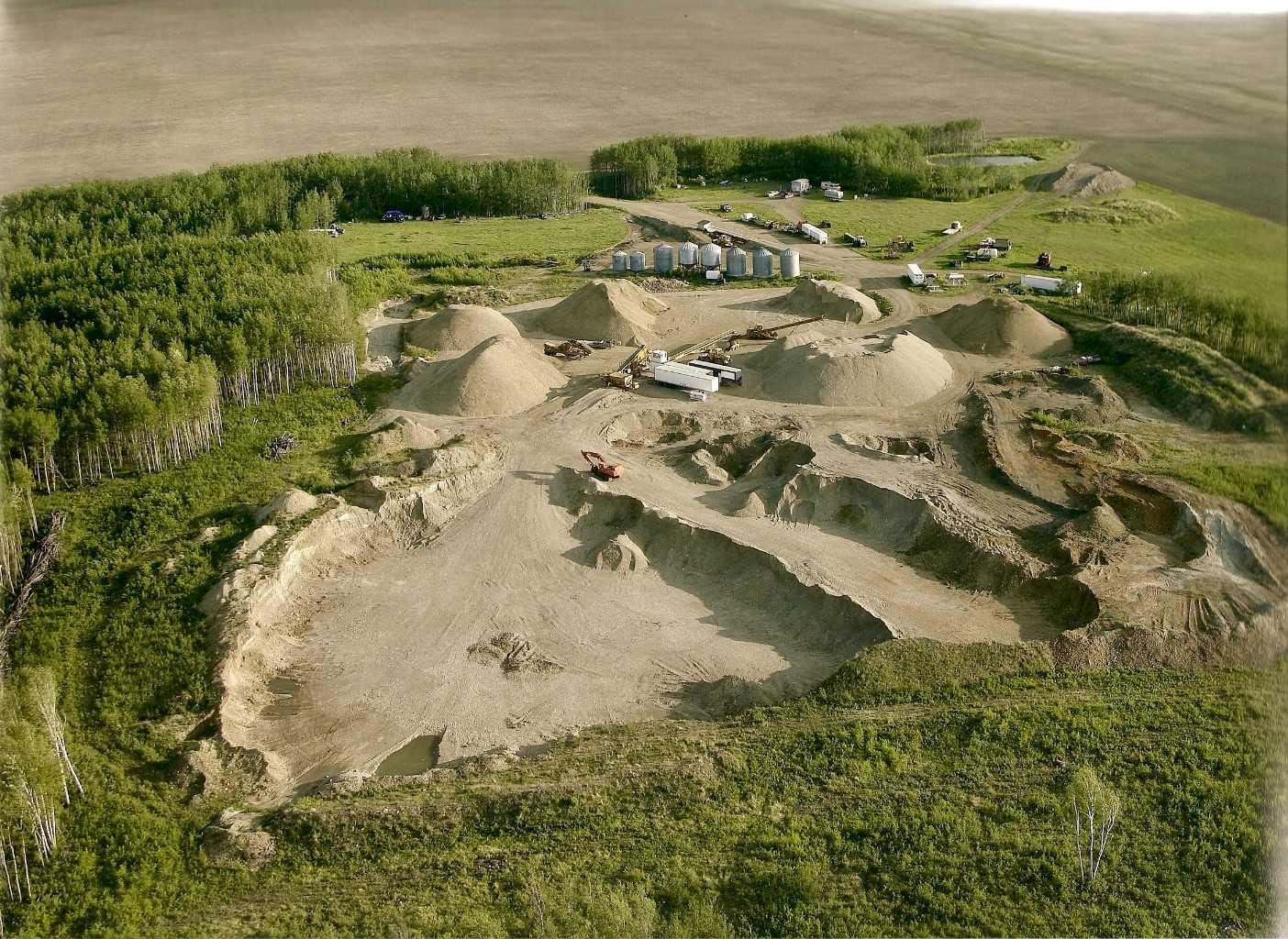 An exceptional opportunity to acquire a fully operational sand and gravel pit in Saddle Hills County, Alberta, offering both immediate cash flow potential and long-term resource value. Located at 6180 Township Road 810, this rare asset combines income-producing land, proven aggregate reserves, and established infrastructure, making it ideal for investors, construction companies, and resource operators. This offering includes 1,318,124 + cubic meters of high-quality sand and gravel, representing approximately $35 million in saleable product at current market pricing. The deposit has been extensively tested and historically meets Alberta Transportation specifications, making it suitable for road construction, municipal projects, oil and gas applications, and agricultural use. Operating for over 20 years, the business has built a strong client base across municipal, commercial, and industrial sectors, providing a solid foundation for continued revenue generation. The sale includes a quarter section of land, with additional rights to explore and extract from surrounding parcels, creating further upside and expansion potential. The property is fully equipped with key infrastructure, including an 80’ x 12’ electronic weigh scale, scale house, and ticketing system, allowing for efficient day-to-day operations. A 42’ x 56’ industrial shop, built in 2009, offers durable construction with a concrete pad, mezzanine office, and future-ready in-floor heating, supporting equipment storage and maintenance. A water license for diversion and gravel washing is in place, along with a current code of practice, ensuring operational continuity and regulatory compliance. This turnkey setup allows a new owner to step in and scale operations immediately. Offered at $7,200,000, this asset presents a compelling investment case with significant remaining reserves and projected strong returns, supported by ongoing demand for aggregate materials across Northern Alberta infrastructure and development projects. This is a rare chance to secure a high-value natural resource asset with proven performance, expansion potential, and long-term income generation in a strategic Alberta location.