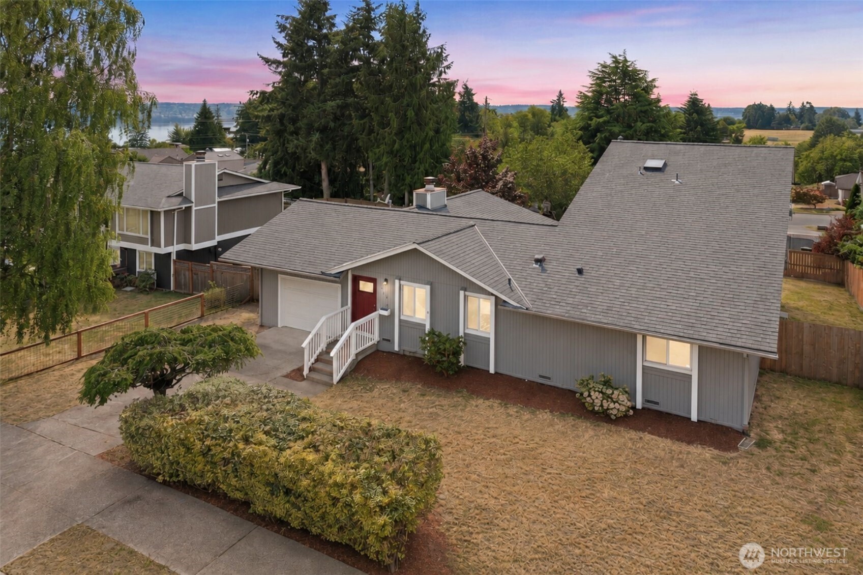 Set in Tacoma’s desirable Browns Point neighborhood, this 5-bedroom, 2-bath home with garage offers room to gather, spread out, and stay awhile. Step inside to natural light that brings warmth throughout the home. The living room with gleaming hard wood flooring flows easily into the kitchen. Glass doors open to the back deck overlooking a spacious yard with views toward Tacoma & the Puget Sound. With a lot size of 8,500 there’s plenty of room for outdoor dinners, gardening, play, or simply relaxing outside. Upstairs, the generous primary suite feels like its own private retreat with a dedicated bathroom and a view worth waking up to. Enjoy taking in the Sound, Tacoma Dome, city skyline & Olympic Mountains every day. Features a versatile 5th room with a closet offering endless options; a 2nd living room, playroom, a bedroom, media room - you choose! Features AC to keep you cool in the summers. Outside your front door, sidewalks allow you to easily explore this neighborhood. Highly rated Browns Point Elementary School is just a quick walk away. Discover the Browns Point Lighthouse & waterfront only 2 miles away or head to Browns Point Playfield & tennis courts just 1.5 miles away. Experience neighborhood favorites including Browns Point Diner, The SandBar, Cliff House Restaurant & Lounge, Saffron Grill, Lighthouse Market and more. At 2,114 sq ft, this solid home has room for everyone, a neighborhood you’ll love being a part of & a community worth exploring. Watch the video!