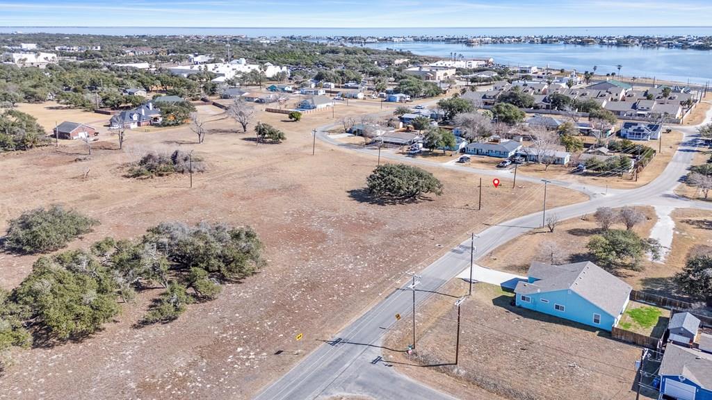 Prime, corner homesite with Majestic Oak – Minutes from Downtown & the Beach! Discover the perfect blend of nature and convenience with this stunning 1-acre tract, featuring a breathtaking ancient oak tree as its centerpiece. Offering versatility, this property can be divided into two half-acre lots or kept as one estate-sized homesite to create your dream retreat. Located just minutes from downtown Rockport, Rockport Beach, festivals, and top-rated restaurants, this prime location provides the best of coastal living with easy access to all the action.