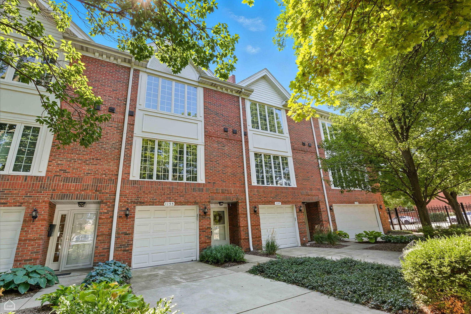 Beautiful & bright, 2 bed, 2.1 bath townhome with family room and attached garage in popular Tri-Taylor area, adjacent to Chicago's famed West Loop! Step into this warm & inviting home, with more than 2,000 square feet spread across 3 levels. This layout actually *does* feel like a single family home, with spacious rooms and thoughtful design that maximizes space & storage. You enter on the main floor, either through your private, attached 1 car garage or your proper entry foyer, and are greeted by a spacious family room with dry bar and the first of 2 fireplaces. This steps out to your private gated patio for outdoor fun. The main living floor has spacious living room with fireplace #2, and a wall of south-facing windows that bathe this room in light. The dining room is connected, and flows to the updated kitchen with quartz counters & stainless steel appliances, and another wall of windows, making this room feel light and bright. Your laundry room is also on this level, with newer machines and additional storage that can be used as a pantry. The top floor features 2 spacious bedrooms - your king-sized primary suite, with full wall of closets and updated primary bath, with skylights, double sinks and walk-in shower. The guest bedroom, with adjacent full bath with tub, also features a wall of closets. Rich, hardwood floors throughout, central air/heat and bonus parking spot on the driveway/parking pad complete this home. All in an intimate, quiet community tucked near the best restaurants and shops along Taylor Street, while conveniently located near all the West Loop has to offer: dining, shops, nightlife, and also convenient to Target, grocery stores, coffee shops and more. Commuter's dream convenient to Blue Line and multiple expressways. Come home!