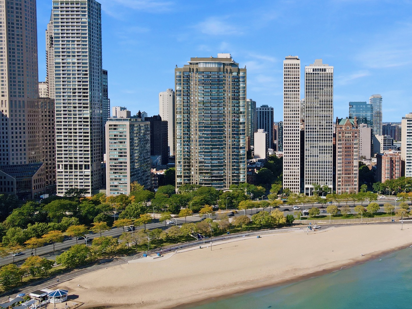 A stunning 3-bedroom, 3.1-bath lakefront residence (3,020 sq ft) on the 31st floor of The Carlyle; one of the finest condominium buildings in the city of Chicago. Its 20-foot terrace affords spectacular and forever unobstructed views of Oak Street Beach and Lake Michigan; historic East Lake Shore Drive and the Streeterville skyline. Watch the annual Air and Water Show from your 31st floor front-row balcony seat! No expense was spared in the complete remodel of this home. The sleek and sophisticated Snaidero kitchen is a chef's dream, equipped with top-tier appliances and complemented by a large dining and informal sitting area that's perfect for entertaining. There is also a large walk-in pantry with a washer and dryer, plus a sink for added convenience. The 27-foot living room offers floor-to-ceiling windows framing stunning lake views, while the elegant formal dining room comfortably seats ten guests for unforgettable meals. The private library/den provides a quiet retreat, and a separate desk area ensures that you have all the space you need for work or study. The master suite is a sanctuary with southerly and westerly views. It includes two dressing areas leading to dual baths, each with radiant floor heating for ultimate comfort. Bedroom 2 also has an ensuite bath with radiant heating. Bedroom 3 is currently being used as a secluded office, adding to the home's versatility. Further features include 9 ft ceilings, recently installed A/V system, a wonderful powder room, ample amounts of storage including a 7' x 6' storage room. There is beautiful hardwood flooring and tiling throughout. One attached valet parking space is included in the monthly assessment with extra parking and guest parking available. The Carlyle is renowned for its world-class amenities where residents enjoy 24-hour door staff, valet parking with EV-charging, and on-site management. The magnificence begins in the lobby and continues 38 stories, up to the rooftop recreation center offering an indoor lap pool, expansive fitness center, sun decks with jaw-dropping views, and a 90 ft ballroom with a catering kitchen - perfect for entertaining or hosting events. There is also an assigned storage locker. Superbly located in the Gold Coast moments from the Magnificent Mile and all the very best Chicago has to offer. 100% owner occupied. No pets or rentals permitted.