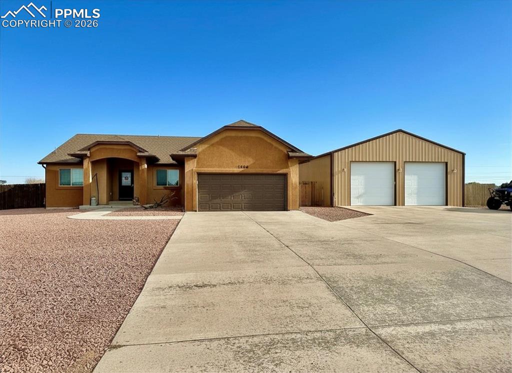 Welcome to a beautifully crafted home built in 2017 by the well-known Sky Creek Homes, featuring the popular Buckeye model. Offering over 3,700 square feet of thoughtfully designed living space, this spacious residence includes 5 bedrooms, 3 bathrooms, a 2-car attached garage, and an impressive 30 x 40 detached shop—perfect for hobbies, storage, or workspace needs. The main level showcases a stunning open floor plan ideal for both everyday living and entertaining. The large kitchen is a true centerpiece, complete with a generous island, hard surface countertops, and rich hardwood flooring that flows seamlessly throughout the space. The expansive primary suite provides a private retreat with a luxurious en suite bathroom and an oversized walk-in closet. Additional features include a fully paid-off solar system for energy efficiency, a radon mitigation system already in place, and a water softener that will remain with the home. With its combination of quality construction, modern amenities, and abundant space—inside and out—this property is a must-see.