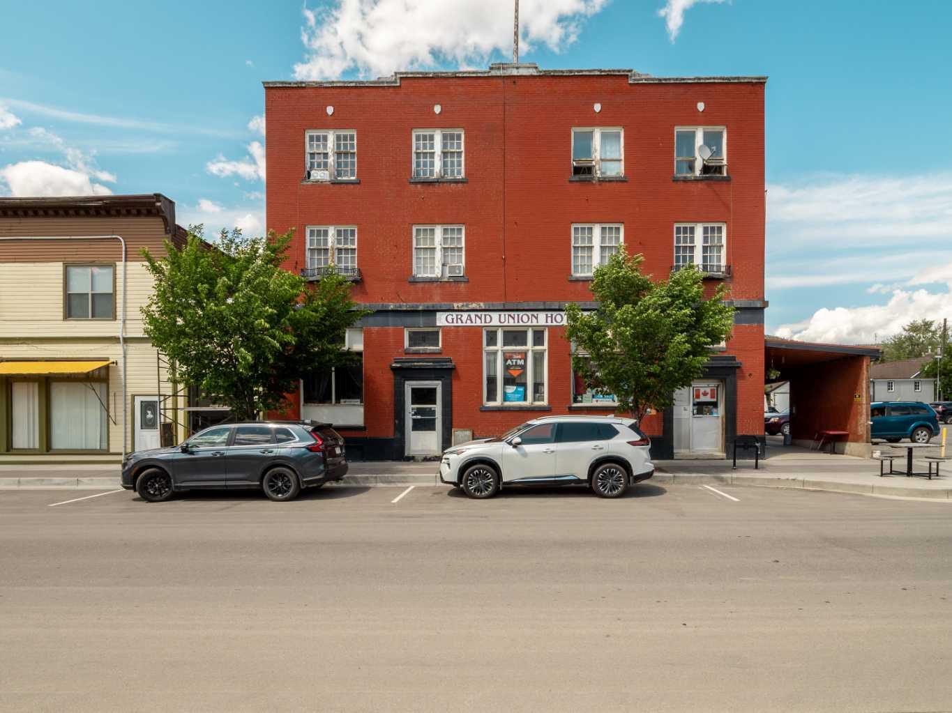 Welcome to the historic Grand Union Hotel, a true landmark that embodies the rich heritage of Coleman. Originally built in 1904 as a wooden structure, it was later reconstructed into its current magnificent brick form in 1924. This iconic establishment holds a significant place in the town's history and offers a unique opportunity for ownership. Under the current ownership, the Grand Union Hotel is thriving with multiple revenue streams. The property features seven Video Lottery Terminals (VLTs) and a vibrant bar on the main level, known for hosting live music events. Additionally, a separate street-facing space is leased for salon services, adding further value to this exceptional property. Ascending to the top floor, you'll discover a beautifully remodeled manager's suite. This spacious suite boasts a comfortable living room, a well-appointed kitchen, three inviting bedrooms, and a bathroom. The top floor also houses ten rental rooms, each equipped with sinks, and two additional bathrooms to cater to the needs of the guests. These rooms are currently operational and generating rental income. Moving to the second floor, you'll find six rental rooms complete with private bathrooms, ensuring the utmost convenience for guests. Additionally, six more rooms are available, each featuring sinks, with two bathrooms specifically designated to serve these rooms. The rooms have been well-maintained, with recent updates enhancing their appeal. The basement of the Grand Union Hotel offers a range of amenities, including coin laundry facilities, two bathrooms, and ample storage space. Mechanical systems have seen recent upgrades, particularly in the heating system, ensuring efficient operation. With the growing trend of development and revitalization in historical downtown Coleman, this property presents a remarkable opportunity for investors. Embrace the chance to be part of the ongoing transformation and capitalize on the potential this esteemed establishment holds. Don't miss your chance to own a piece of history and become a steward of the Grand Union Hotel. Contact your favorite REALTOR® to schedule a viewing today and explore the possibilities that await in this thriving and historically significant location.