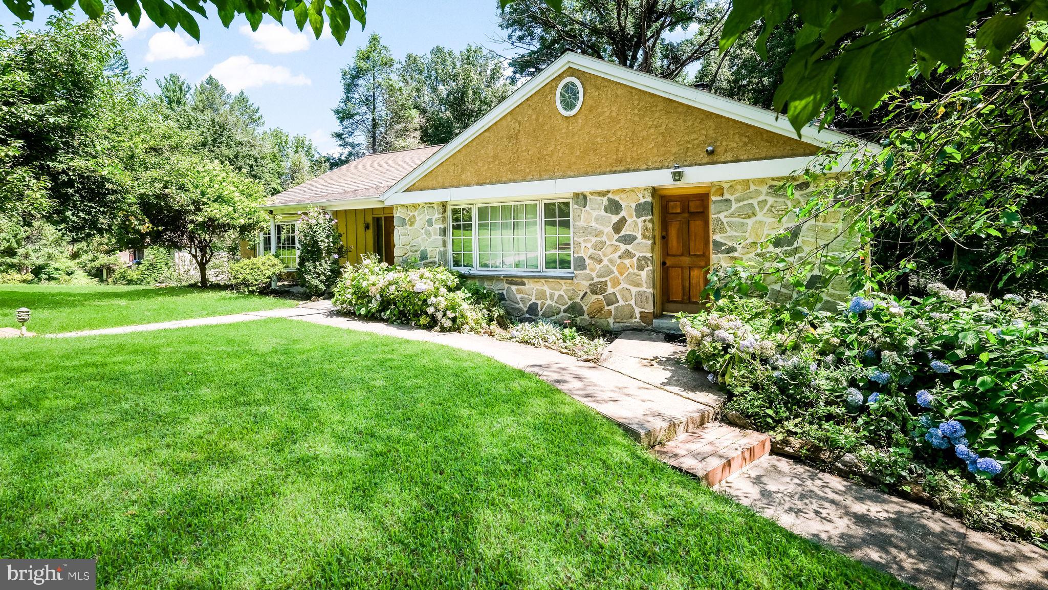 Welcome to this lovely and spacious three-level home situated on close to 2 acres in one of Lower Merion's most prestigious neighborhoods. This charming property features 6 bedrooms, 2 full bathrooms, and 1 powder room. The lower level features the 2-bedroom in-law or au pair suite with wall-to-wall carpeting, a full expanded modern bathroom with an accessible shower configuration, and a spacious den area with a wet bar and two brick wood-burning fireplaces. Doors from this level lead to the rear yard and patio, with rear stairs leading to a wood deck. This level offers excellent flexibility for multigenerational living and guest accommodations.The main level features a spacious eat-in kitchen with a large breakfast nook, along with a formal dining room, spacious living room, and modern powder room. Beautiful hardwood flooring adds warmth and character to the main living areas. The kitchen and main level also provide access to the rear deck and stairs. A laundry area includes a washer, dryer, and second refrigerator, with an additional door providing access to the front yard.The upper level features 4 bedrooms, a full modern bathroom, beautiful hardwood flooring, and ample closet space. The property also includes a small basement and an attached 2-car garage with direct access to the home. The garage offers abundant cabinet storage, a remote garage door, and an additional door leading to the basement. The long, spacious driveway provides parking for an additional 4-5 vehicles, with additional street parking available.The expansive rear yard offers excellent potential for a pool, hot tub, or other outdoor amenities. A lovely lighted cement walkway leads from the main front entrance to the mailbox at street level. Ideally located near major roadways for an easy commute to Center City and surrounding areas. The Wynnewood Train Station is just minutes away, with convenient access to shopping, schools, supermarkets including Whole Foods, Giant, and Acme, numerous restaurants, drug stores, FedEx, car dealers, banks, religious institutions, and other amenities. Philadelphia International Airport is also conveniently located nearby.A wonderful opportunity to own a spacious and versatile home in one of the Main Line's most sought-after locations.