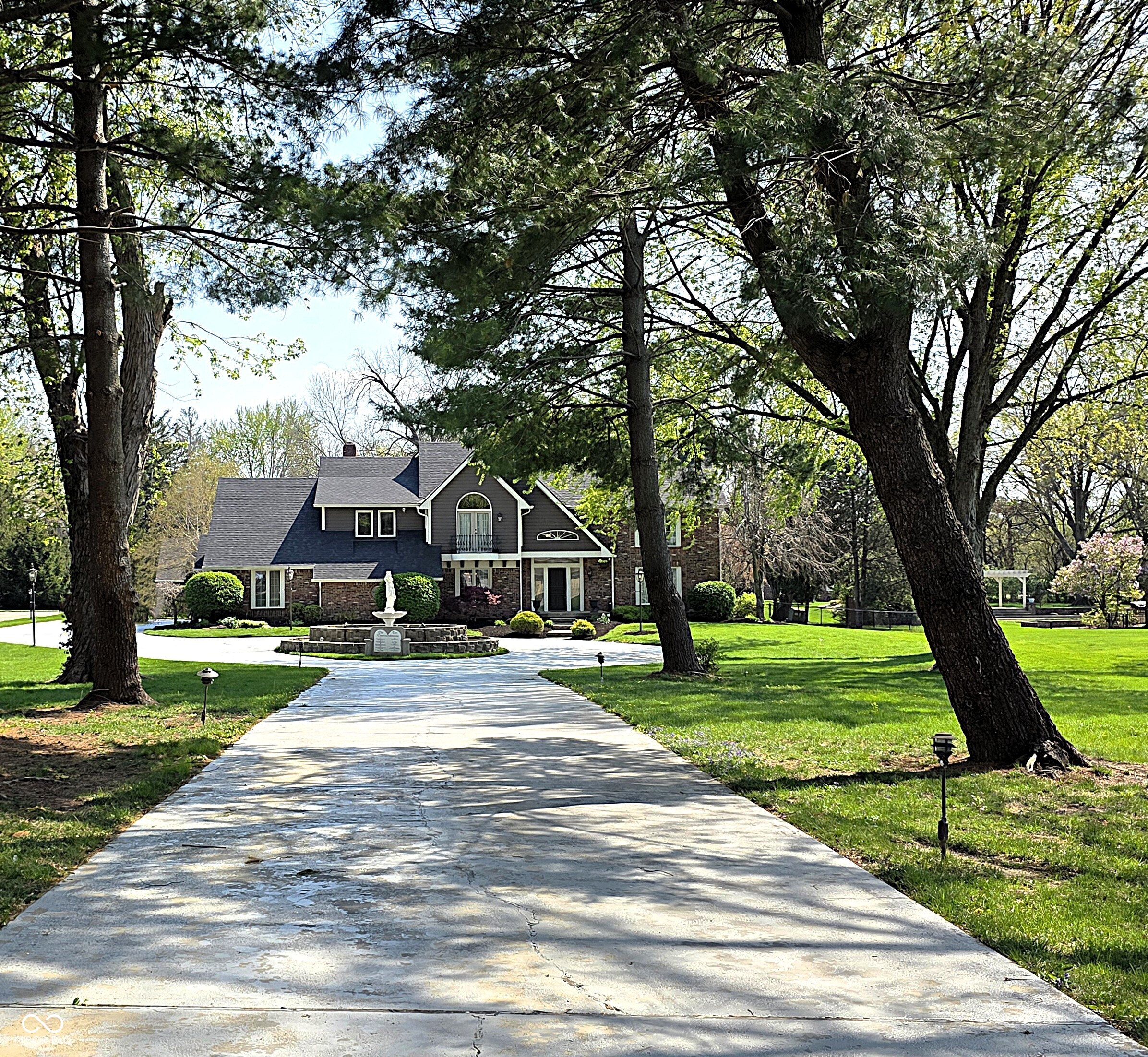 Once in a lifetime LUXURY estate on 1.7 manicured acres just moments from downtown Indy. A private gated entrance welcomes you down the long tree-lined driveway featuring large fountain. Step inside the grand entryway and fall in love. Enjoy the finely detailed circular staircase, palatial formal living room w/cozy fireplace & tall windows, open breakfast room & elegant dining room, state-of-the-art kitchen w/center island, stainless appliances and gorgeous granite counters, family room w/floor-to-ceiling bookshelves, 2 laundry rooms for convenience, dramatically proportioned sunroom perfect for year around entertaining, sumptuous primary suite w/view, fireplace, windowed walk-in closet, en-suite bath w/triple mirrors, full shower, soaking tub and music room off to the side, big bedrooms, sun-drenched office and finished basement w/additional bedroom, game room, wet bar and rec room. Tranquil backyard w/in-ground pool, multi-level deck system featuring outdoor kitchen area w/gas grill, gazebo, stoned patio and covered sitting area. Plus, separate guest house and 33x18 garage perfect for all of your storage and toys. This 5978 sqft residence offers the ultimate in living for those unwilling to compromise.
