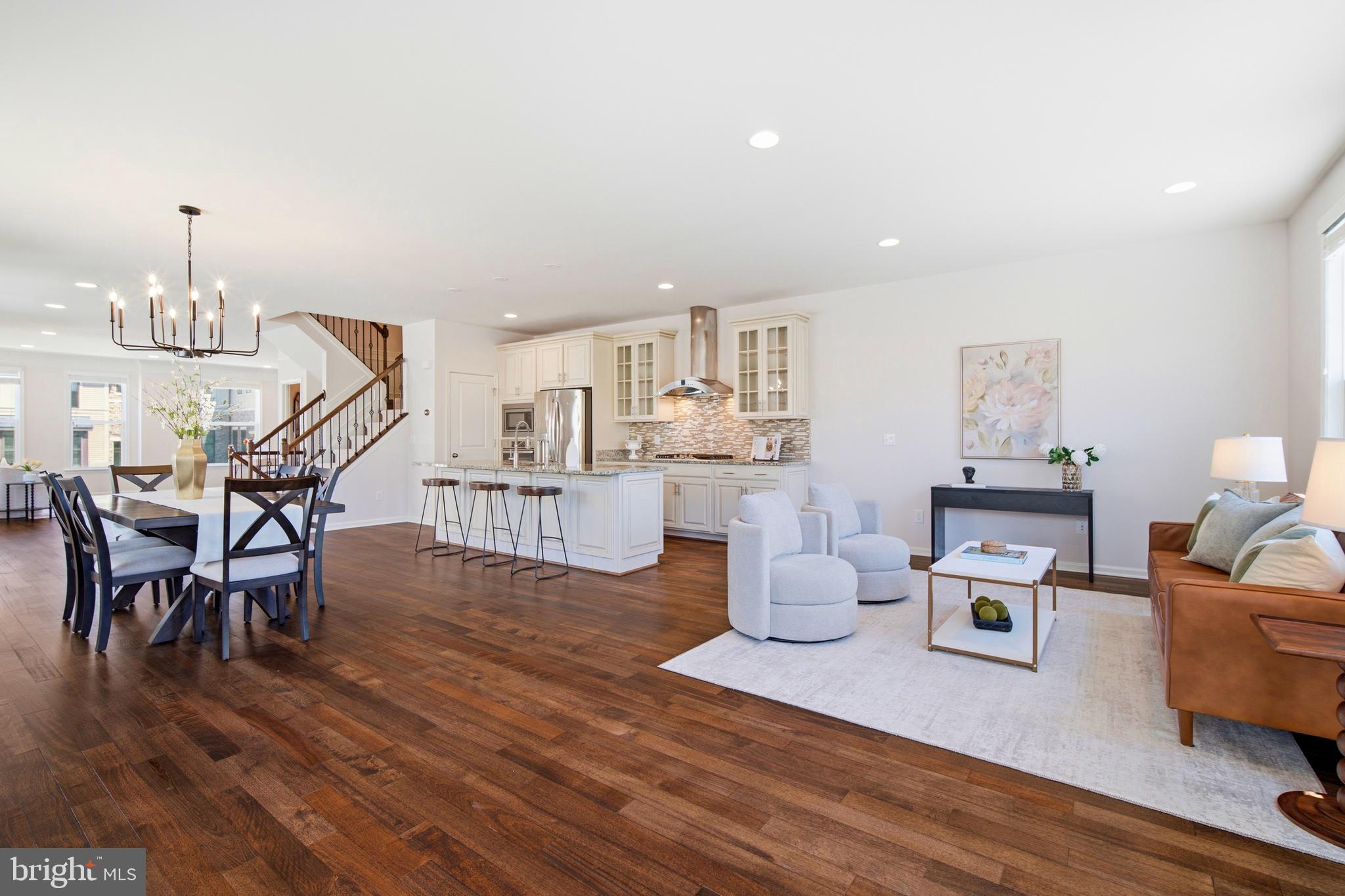 Experience single-family living in this magnificent 24-foot-wide END townhome. Start your day with vibrant morning sunrises & unwind with stunning golden sunsets from EAST-FACING front door. Entertainment options are expanded by multiple outdoor retreats, including a REAR DECK off the great rm, a covered SIDE BALCONY off the living area, & a FENCED BACKYARD off of the rec rm.Welcome to 3,263 sq ft precious home for its elevated living! From the distinctive architecture & classic brick exterior to the covered stoop & sleek frosted front door that brings in light, yet keeping it private, this incredible home leaves a lasting impression. Inside, enjoy a bright, open floor plan spanning three finished levels, complete w/4 bedrooms, 3 luxury full baths handsomely appointed w/ceramic tiles + upgraded countertops & 2 upgraded half baths. Attached, FRONT LOAD 2-car garage featuring lited doors, an automatic opener, & a convenient exterior keypad.Step into this home where exceptional value meets meticulous care. FRESH PAINT to entire home, NEWLY installed plush CARPET flows throughout the upper & lower levels, including the stair runner, the main & upper hallway shines w/gleaming HARDWOOD floors, OAK staircase featuring elegant wrought iron spindles at all flights, soaring 9-FOOT ceiling paired w/8-FOOT exterior doors, TRAY ceiling at primary, numerous long windows maintaining ventilation at all times, architectural details to include crisp TRIMS & SHADOW BOXES, & warm lighting enhances the home's overall aesthetics. To add, nest thermostat, custom blinds, ceiling fan/prewires, & strategically placed media points.Experience the ultimate blend of formal elegance & everyday comfort on this extensive main level. The open-concept design creates a seamless flow between the living room, formal dining area, kitchen, great rm, & office spaces, making everyday living a breeze. This highly adaptable layout offers endless possibilities, allowing you to easily customize the space to fit your family's unique lifestyle. The show-stopping chef's gourmet kitchen features a huge center island-perfect for meal prep, casual dining, workspace, homework, & entertaining. It offers glazed cabinetry, elegant granite counters, a stylish backsplash, premium stainless steel appliances, and a tucked-in pantry. Upstairs, the luxurious primary suite features DUAL walk-in closets & a spa-like bath w/separate vanities, a large walk-in shower, a soaking tub, & a private water closet. Down the hall are two spacious secondary bedrooms, a shared full bath, & a highly convenient BED RM LEVEL LAUNDRY. Perfect for hosting, the expansive lower level offers a true entertainer's paradise. Relax in the massive recreation area by the cozy corner fireplace, &  enjoy the convenience of a private bedroom w/a full bath, plus an extra powder room for guests.HOA includes Verizon FIOS package for CABLE & INTERNET, lawn mowing, trash, & snow removal. Access to 5 community pools, 3 club houses available to rent, 18 playgrounds & tot lots, 18+ miles of paved trails across the neighborhood, more than 250 acres of green space, a wide array of parks, beautiful laid ponds w/fish, lighted tennis, sand volleyball, basketball courts, children’s zipline, bike track, dog park, & little library. Association offers programs like art, dance, drama, summer camps for all ages, & community seasonal events organized throughout the year. BRAMBLETON TOWN CENTER: State of the art library, One Life fitness, farmers market, groceries, movies, gas station, restaurants, pharmacy, boutiques, meeting places, two daycare centers, & much more.Minutes to HAL & BERNI HANSON REGIONAL PARK (a 257 acre park), 267 Greenway/Toll, public transportation, Ashburn Station Metro (Silver Line), INOVA, Dulles International Airport,Loudoun Station, Broadlands Village, One Loudoun, & Dulles Landing. Top rated schools. Excellence in location & convenience.